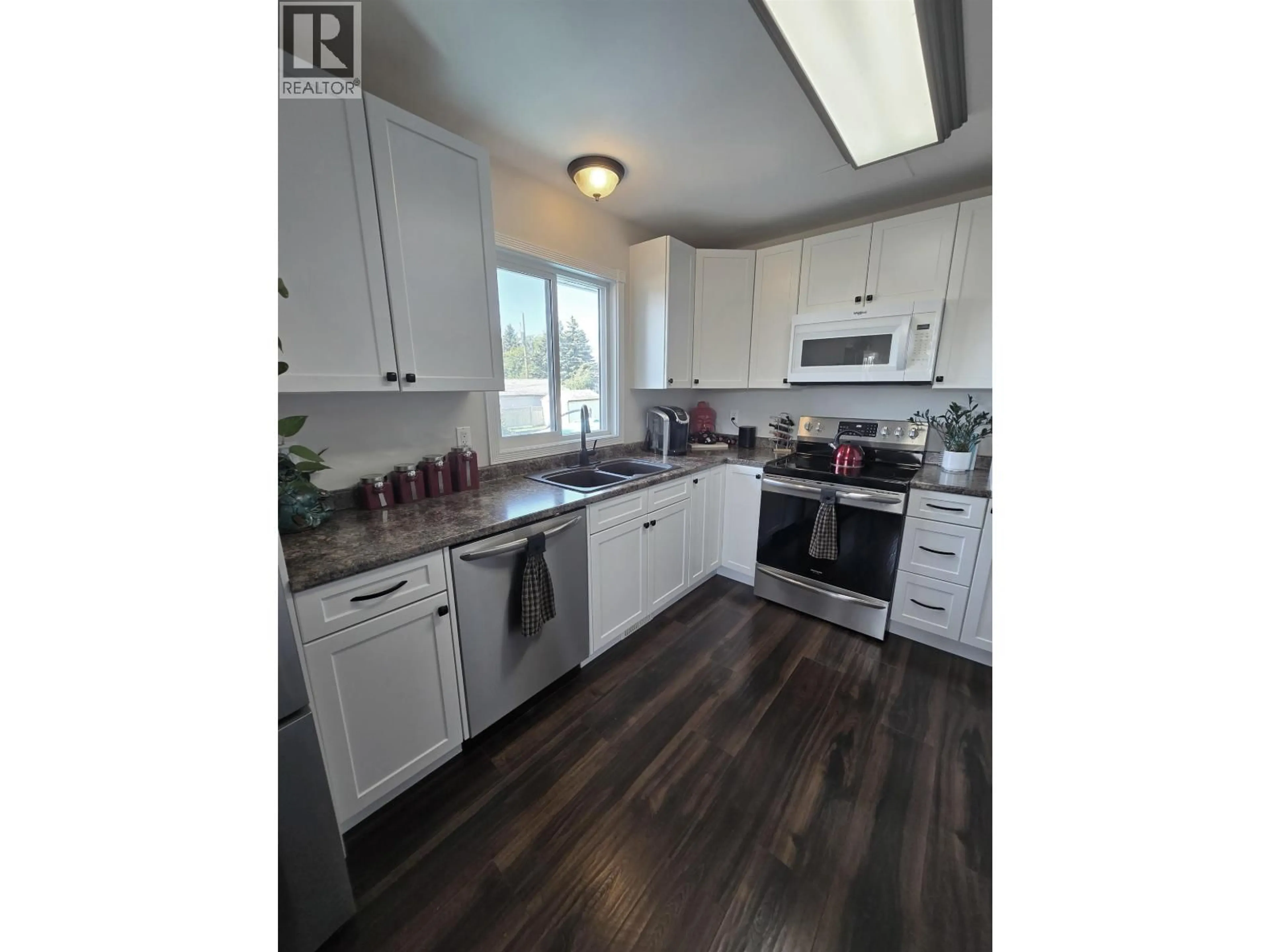 Open concept kitchen, wood/laminate floor for 10604 92 STREET, Fort St. John British Columbia V1J3J3