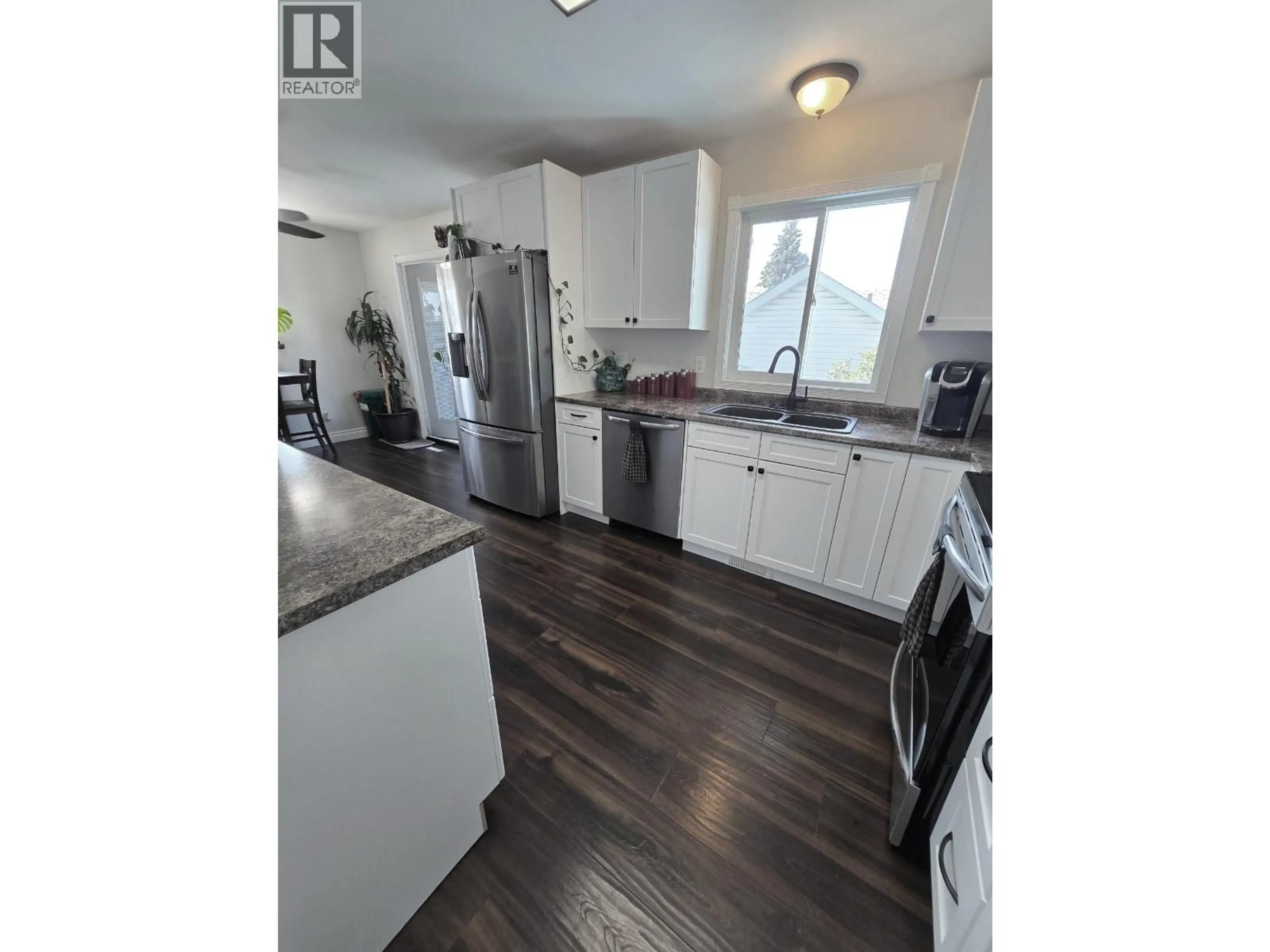 Open concept kitchen, wood/laminate floor for 10604 92 STREET, Fort St. John British Columbia V1J3J3