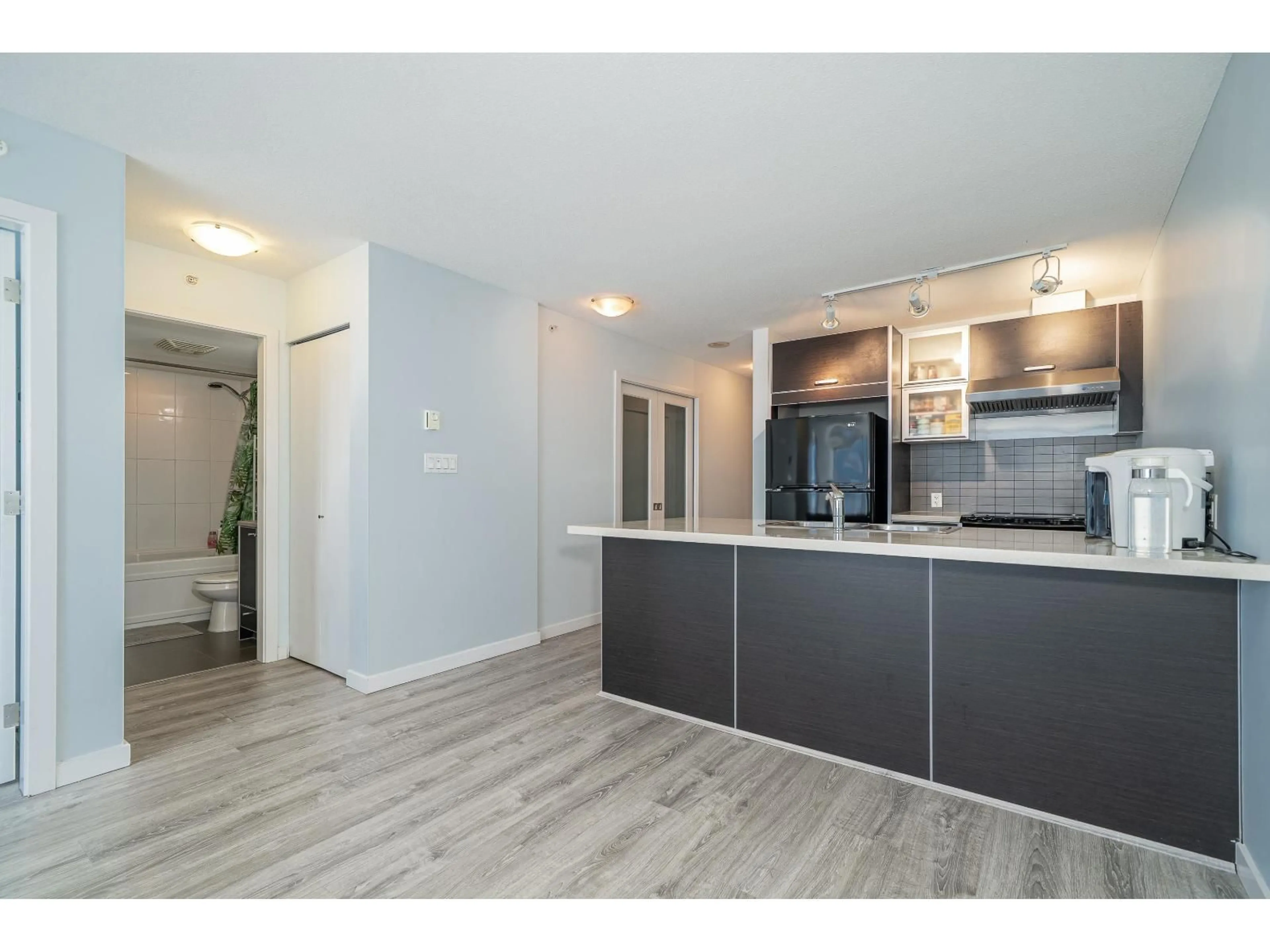 Open concept kitchen, wood/laminate floor for 2303 - 13688 100, Surrey British Columbia V3T0G5