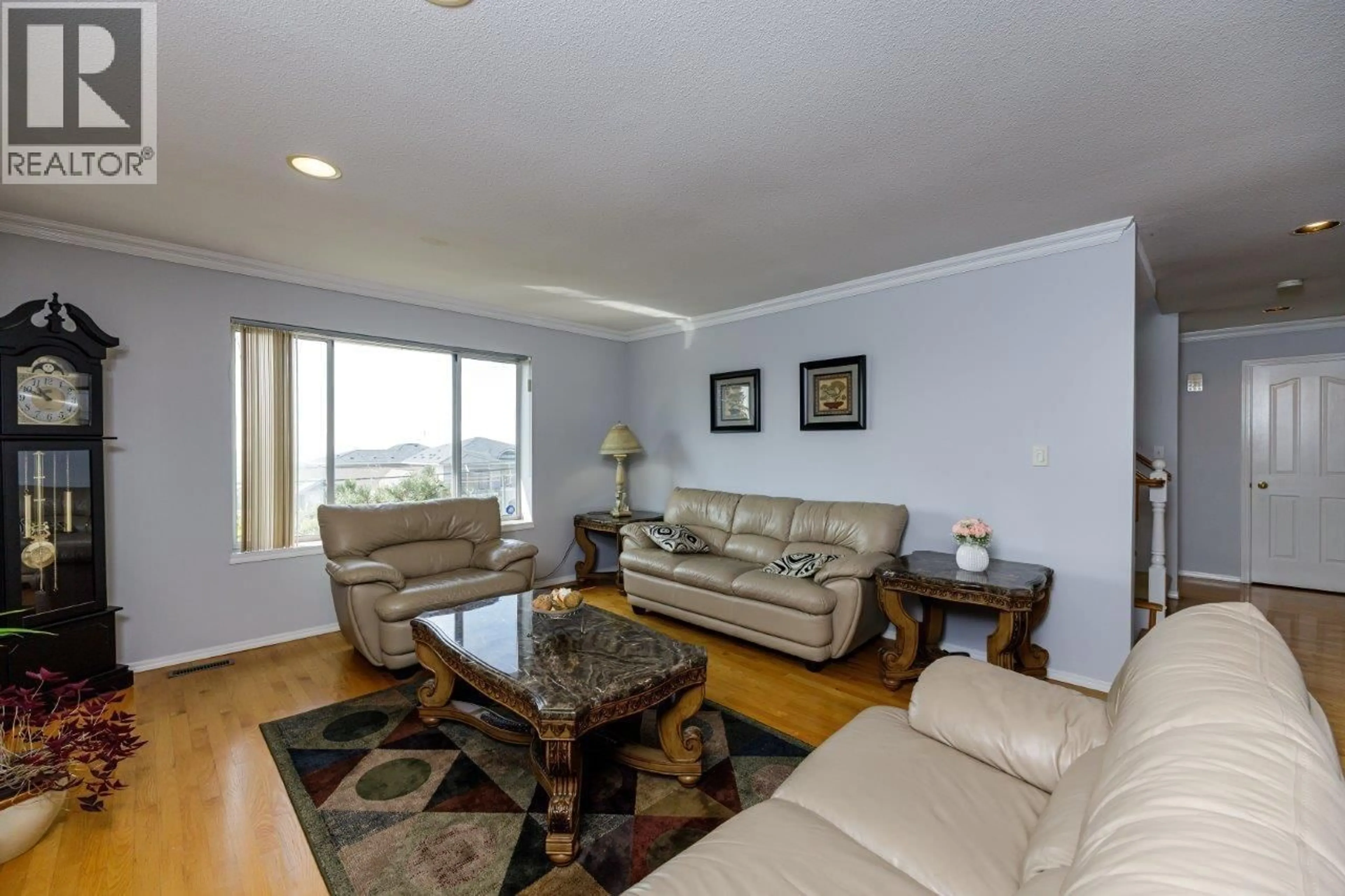 Living room with furniture, wood/laminate floor for 4549 PORTLAND STREET, Burnaby British Columbia V5J2P1