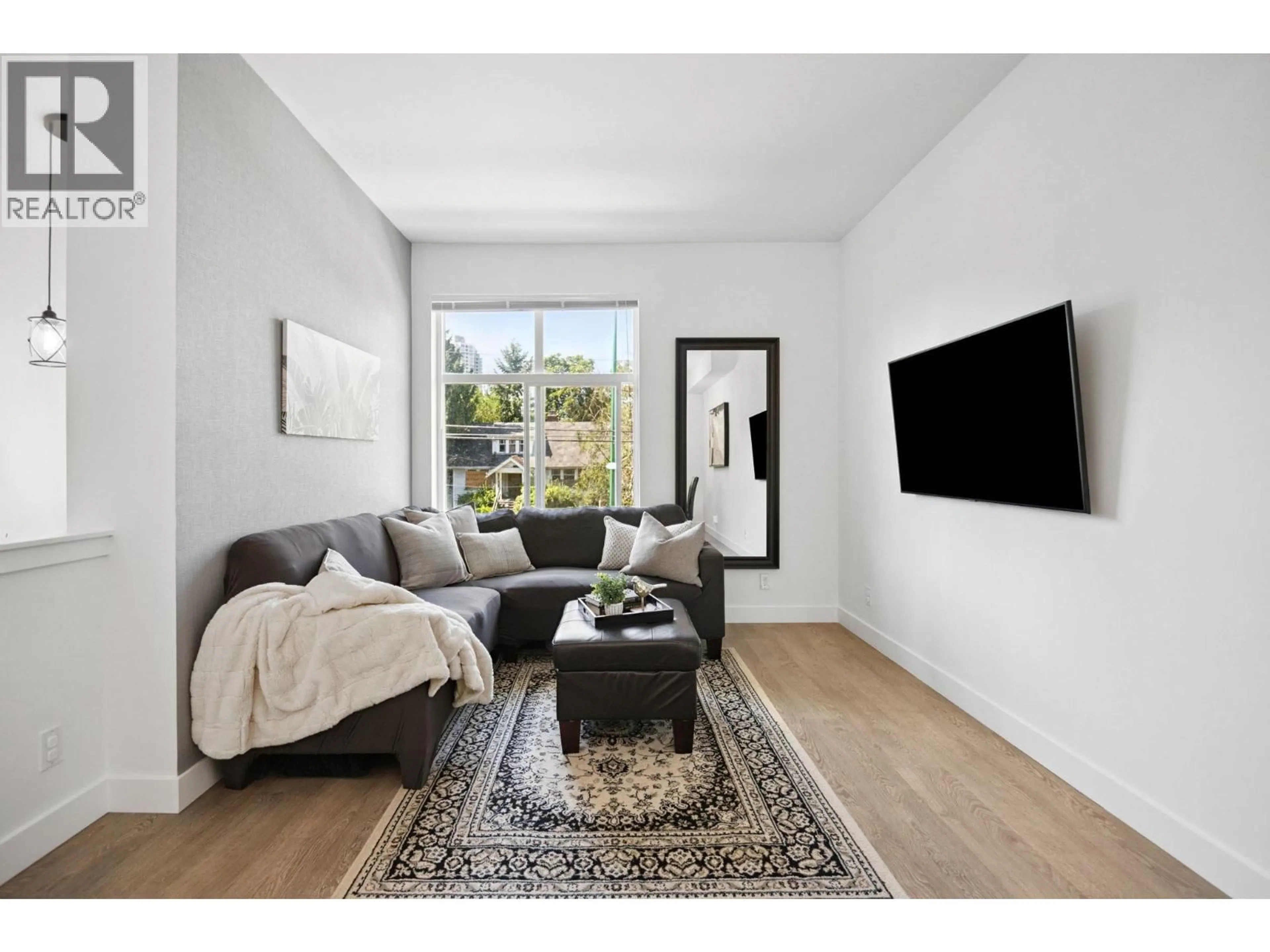 Living room with furniture, unknown for 207 - 7250 18TH AVENUE, Burnaby British Columbia V3N1H3