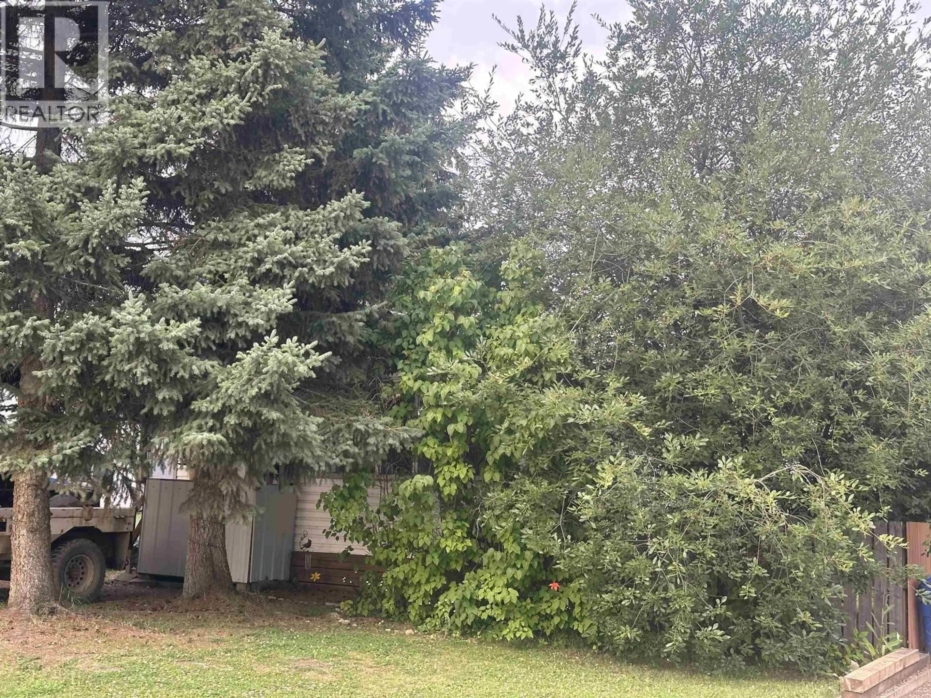 A pic from outside/outdoor area/front of a property/back of a property/a pic from drone, forest/trees view for 8724 75 STREET, Fort St. John British Columbia V1J2Y8