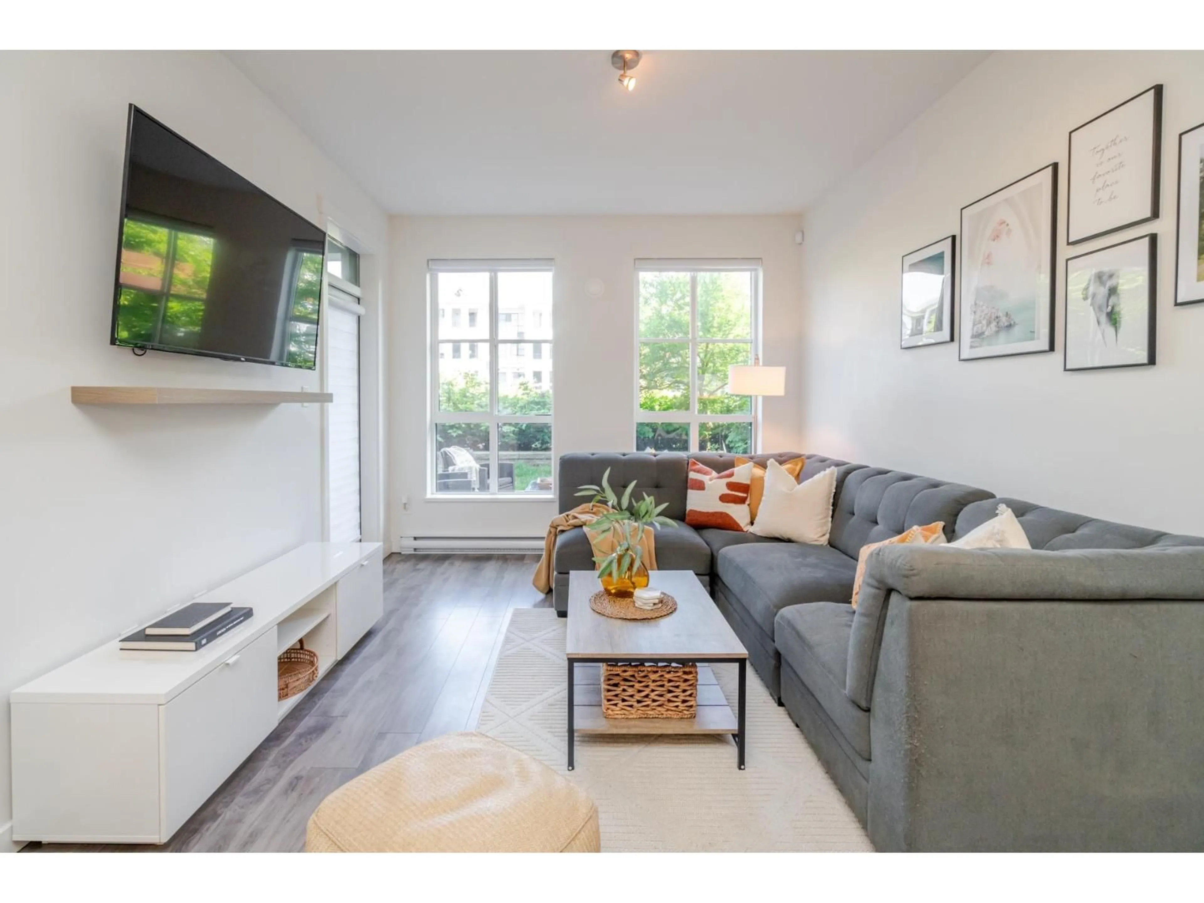 Living room with furniture, wood/laminate floor for 101 - 15137 33, Surrey British Columbia V3Z0Y1