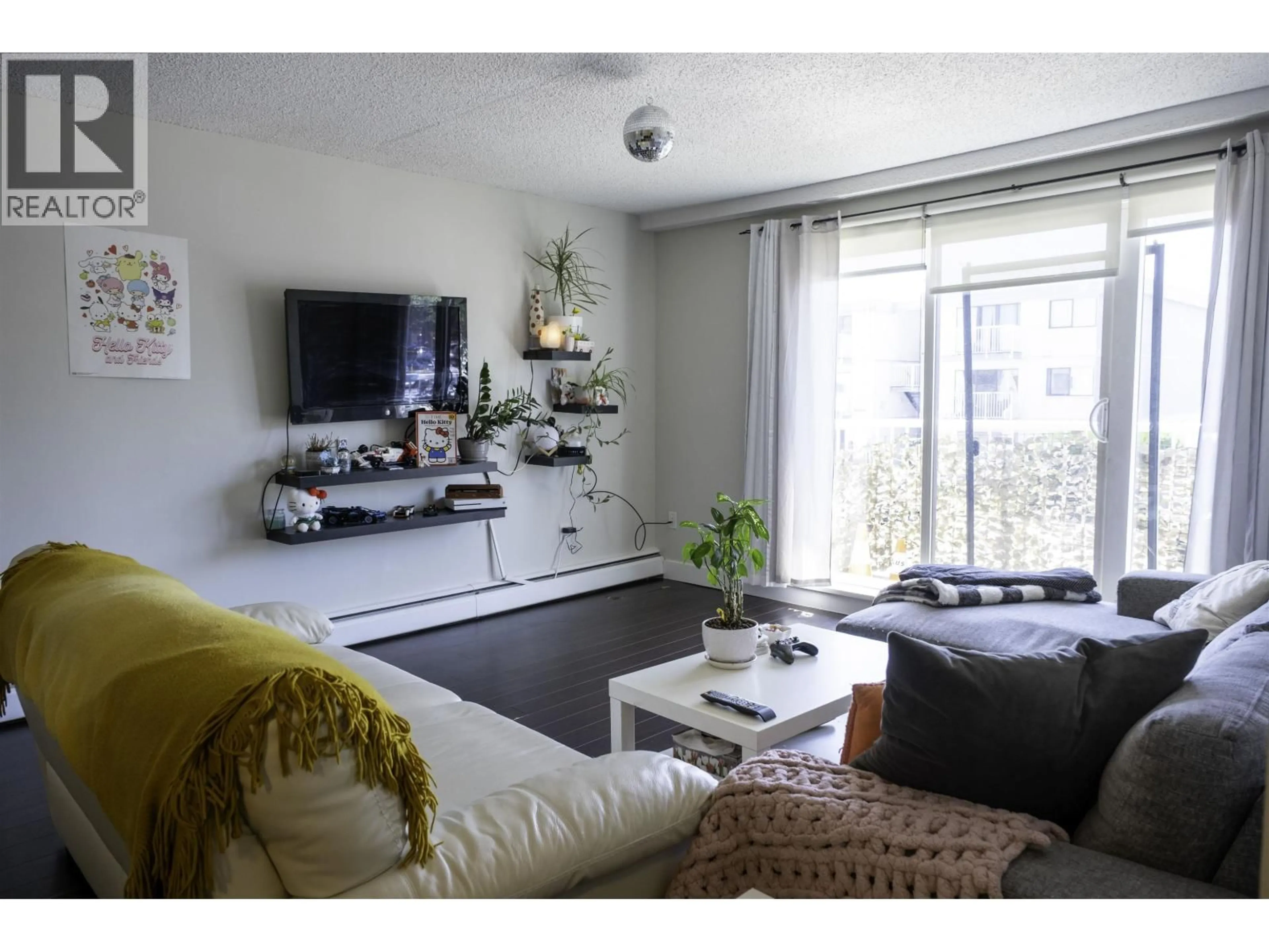 Living room with furniture, wood/laminate floor for 205 - 7180 LINDSAY ROAD, Richmond British Columbia V7C3M6