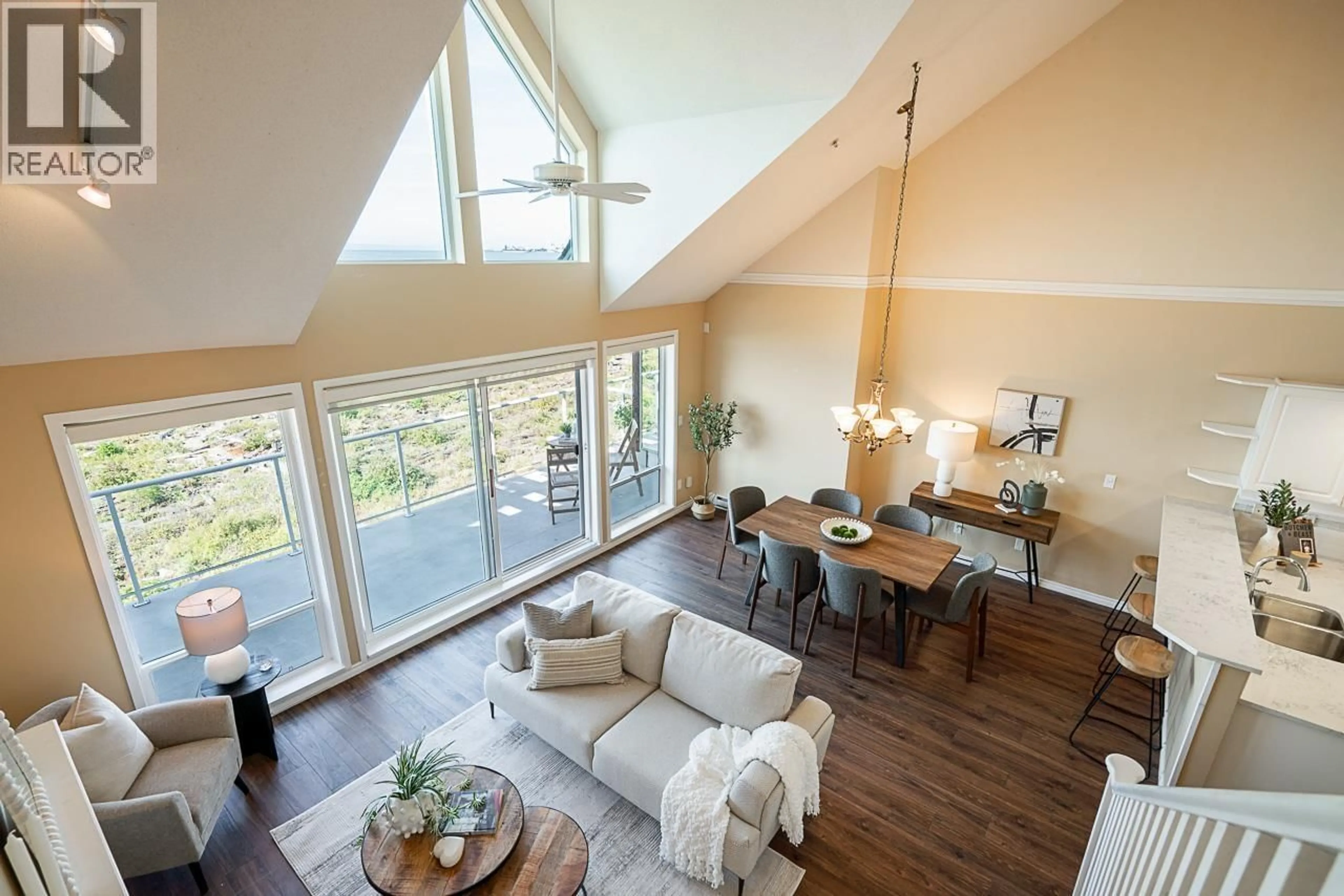 Living room with furniture, wood/laminate floor for 407 - 1120 TSATSU SHORES DRIVE, Delta British Columbia V4M4G3