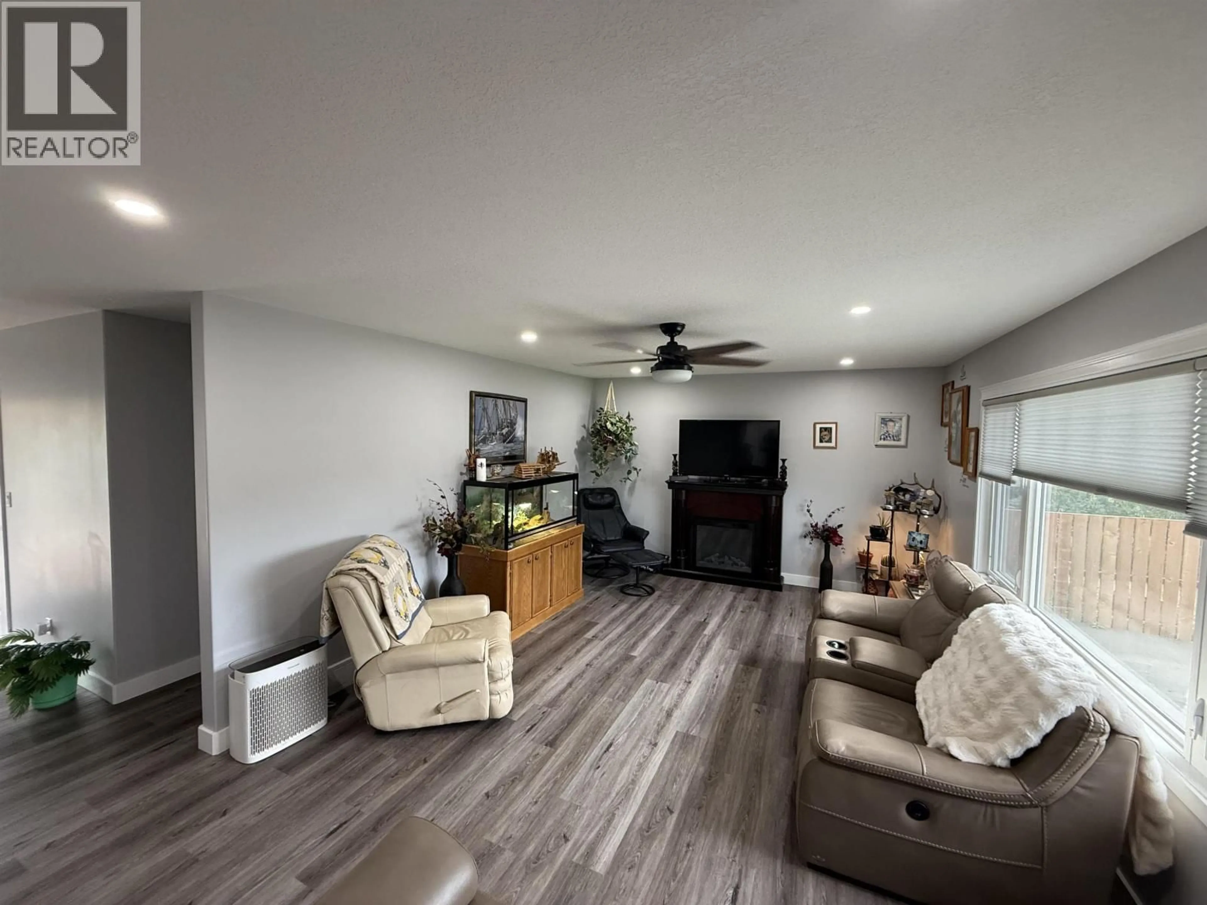 Living room with furniture, wood/laminate floor for 9520 96 AVENUE, Fort St. John British Columbia V1J1K7