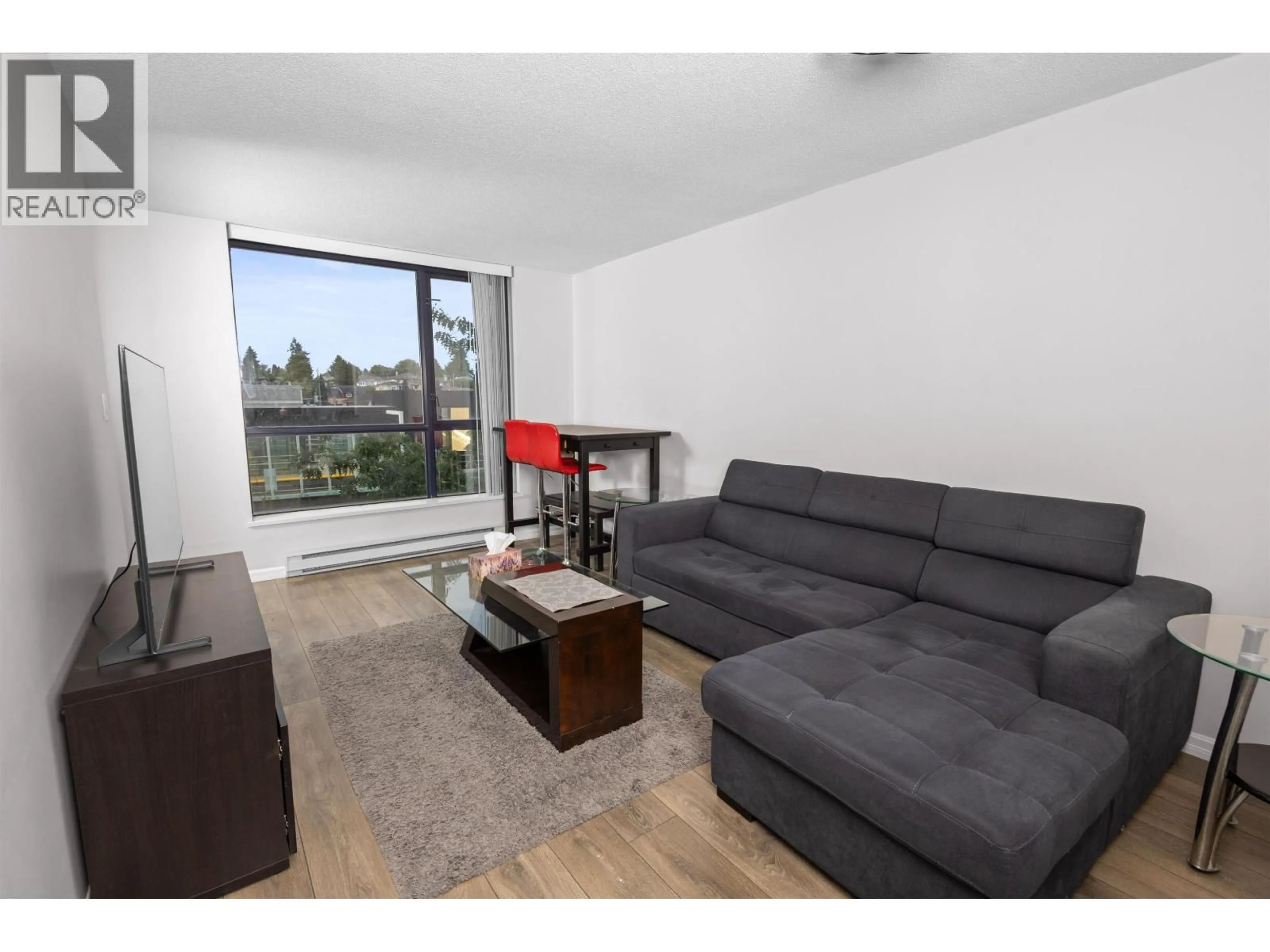 Living room with furniture, wood/laminate floor for 502 - 3438 VANNESS AVENUE, Vancouver British Columbia V5R6E7