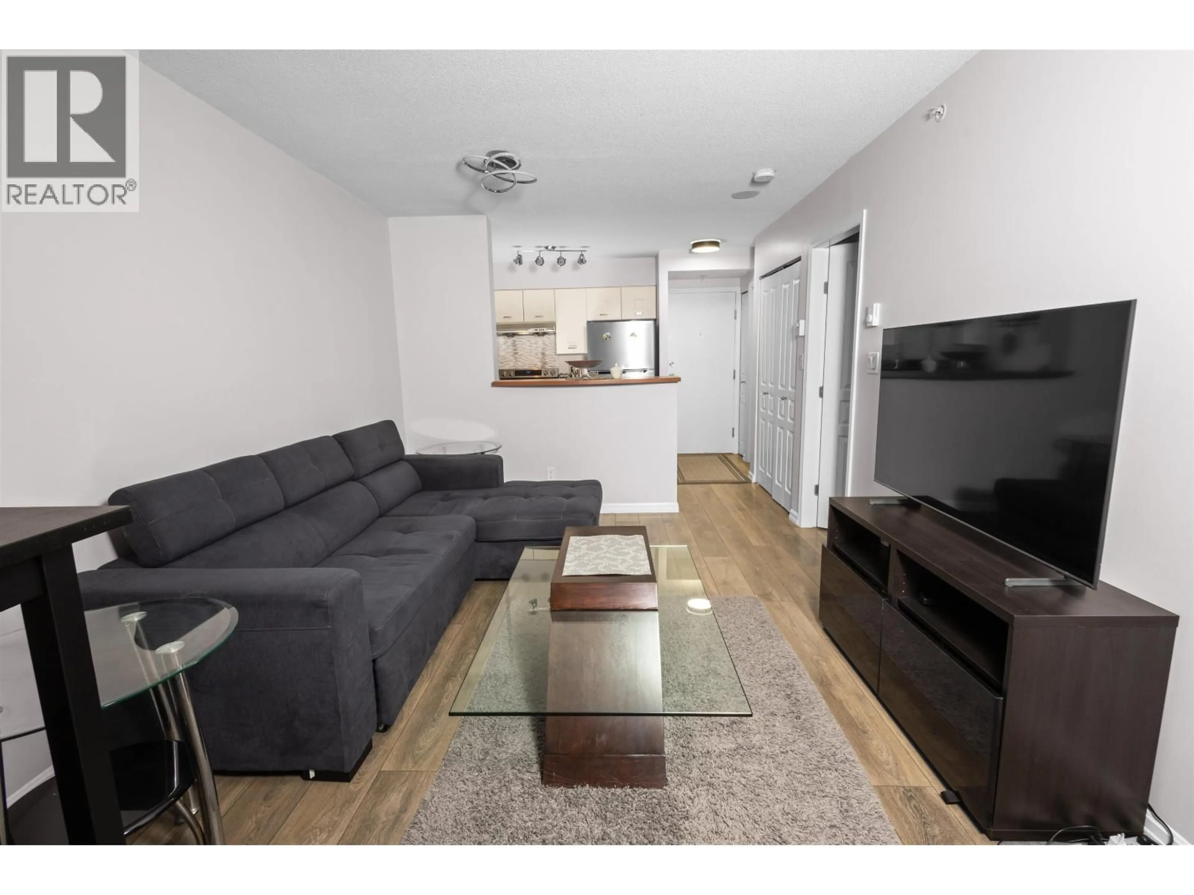Living room with furniture, wood/laminate floor for 502 - 3438 VANNESS AVENUE, Vancouver British Columbia V5R6E7
