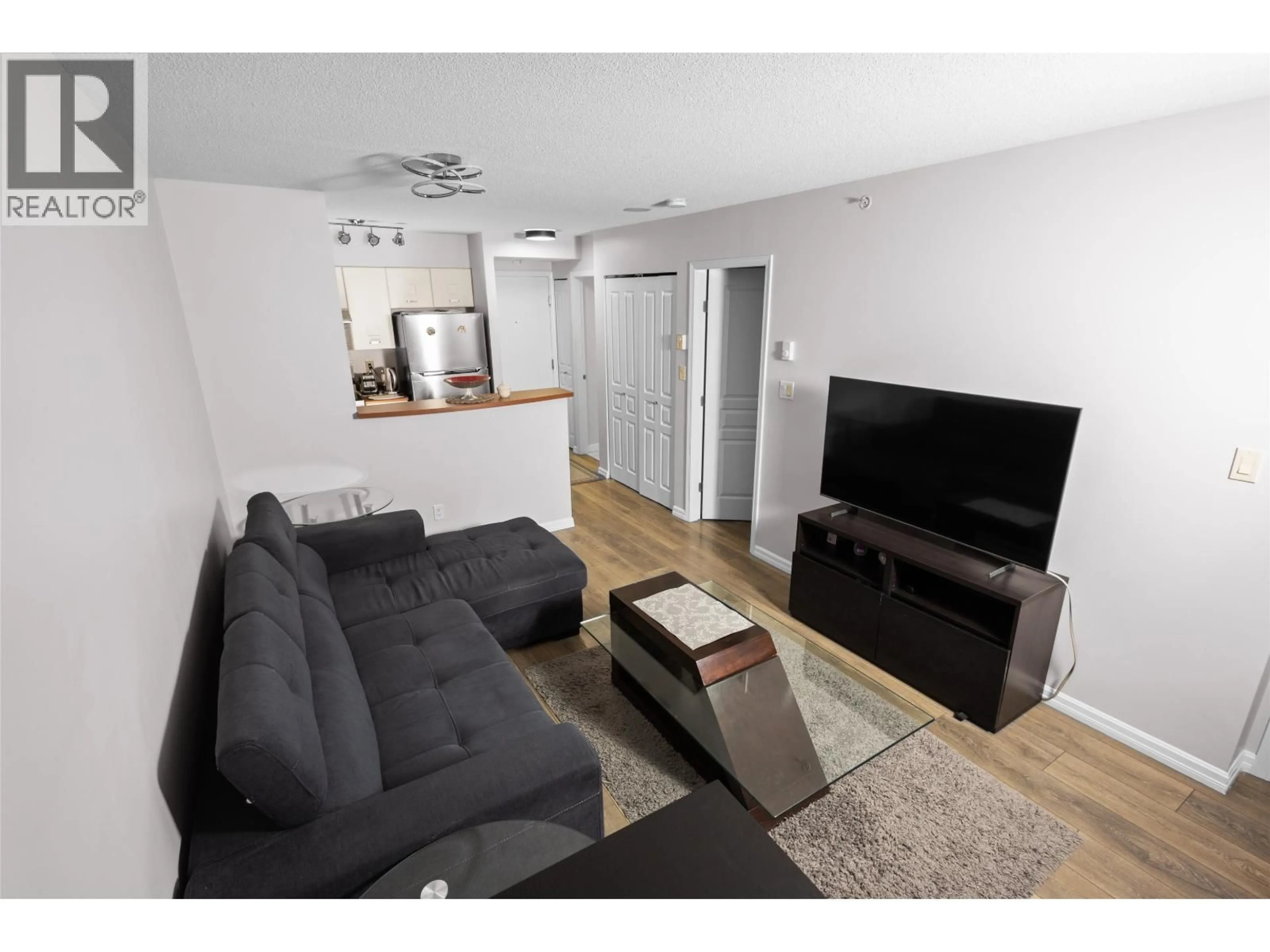 Living room with furniture, wood/laminate floor for 502 - 3438 VANNESS AVENUE, Vancouver British Columbia V5R6E7