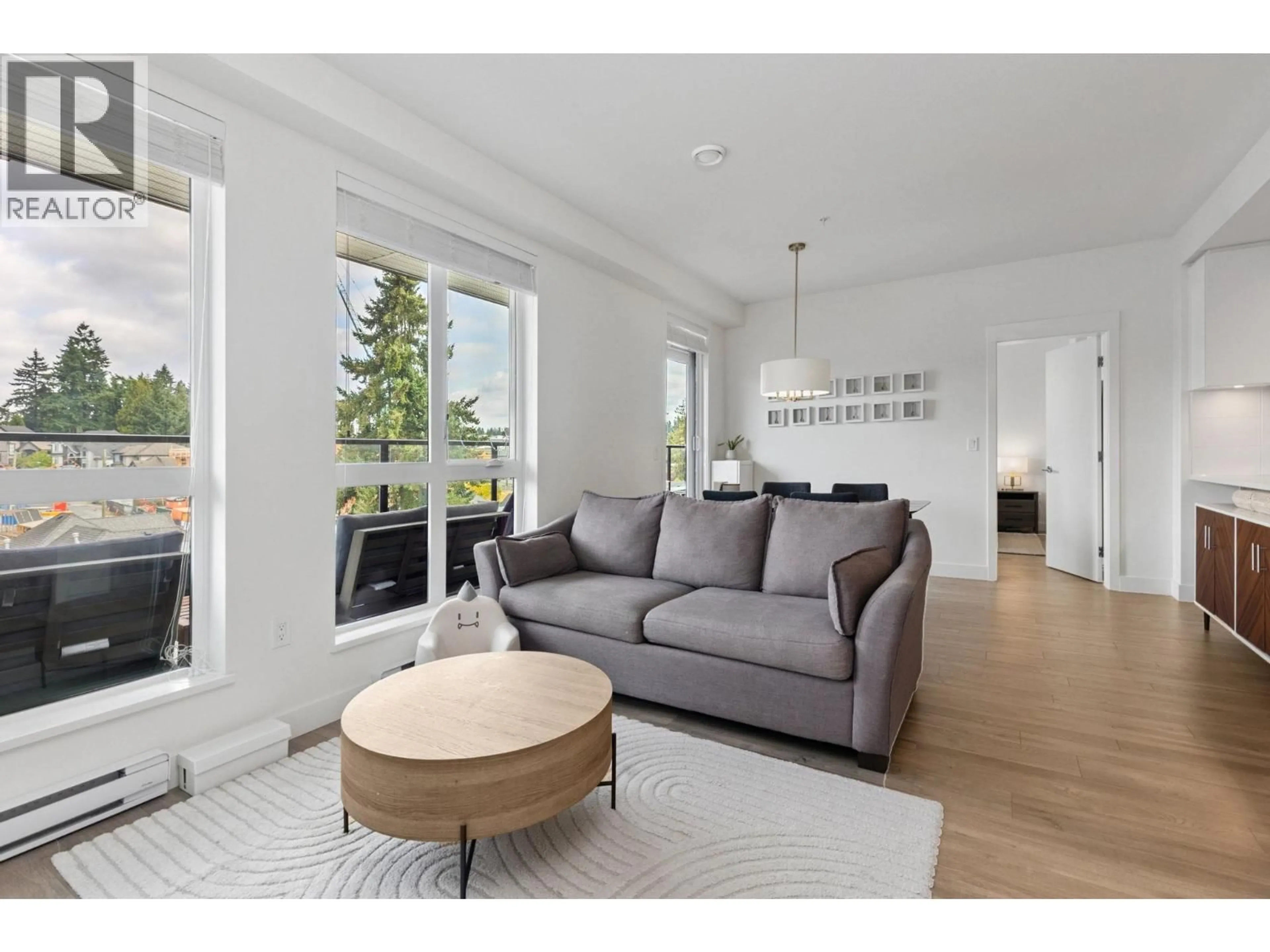 Living room with furniture, wood/laminate floor for 502 - 750 DOGWOOD STREET, Coquitlam British Columbia V3J0K6