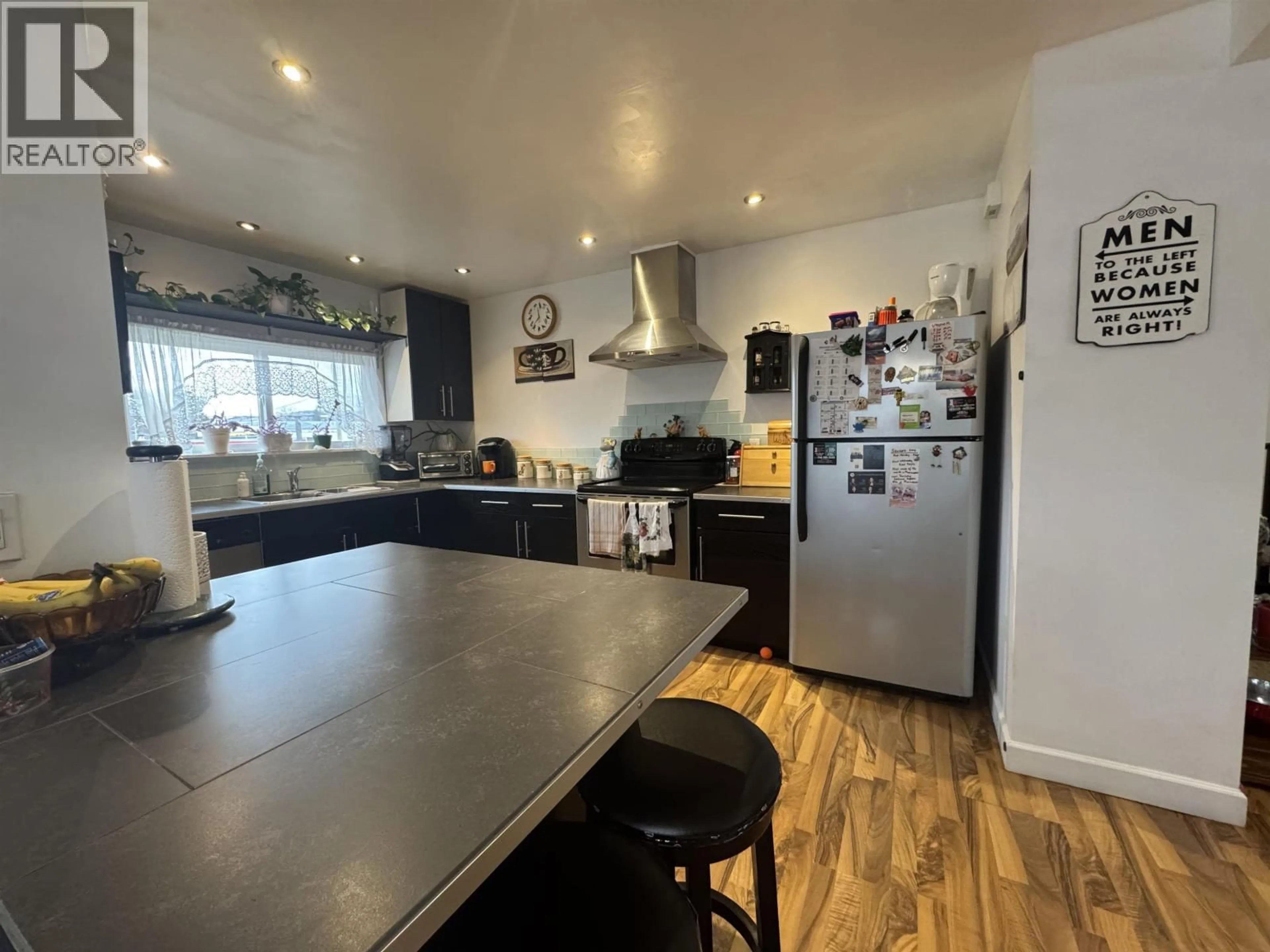 Open concept kitchen, wood/laminate floor for 360 CEDAR AVENUE, 100 Mile House British Columbia V0K2E0