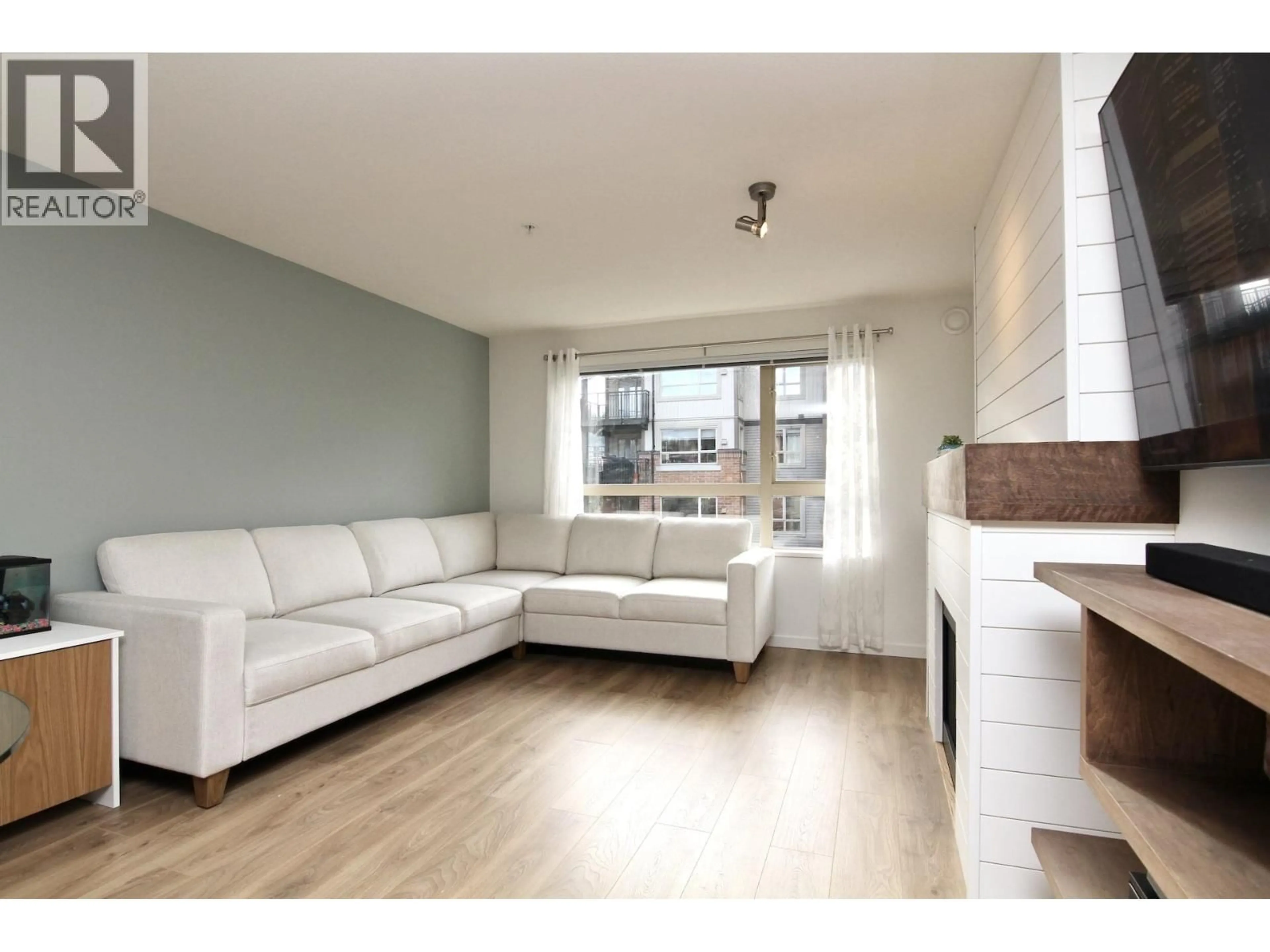 Living room with furniture, wood/laminate floor for 317 - 700 KLAHANIE DRIVE, Port Moody British Columbia V3H5L3