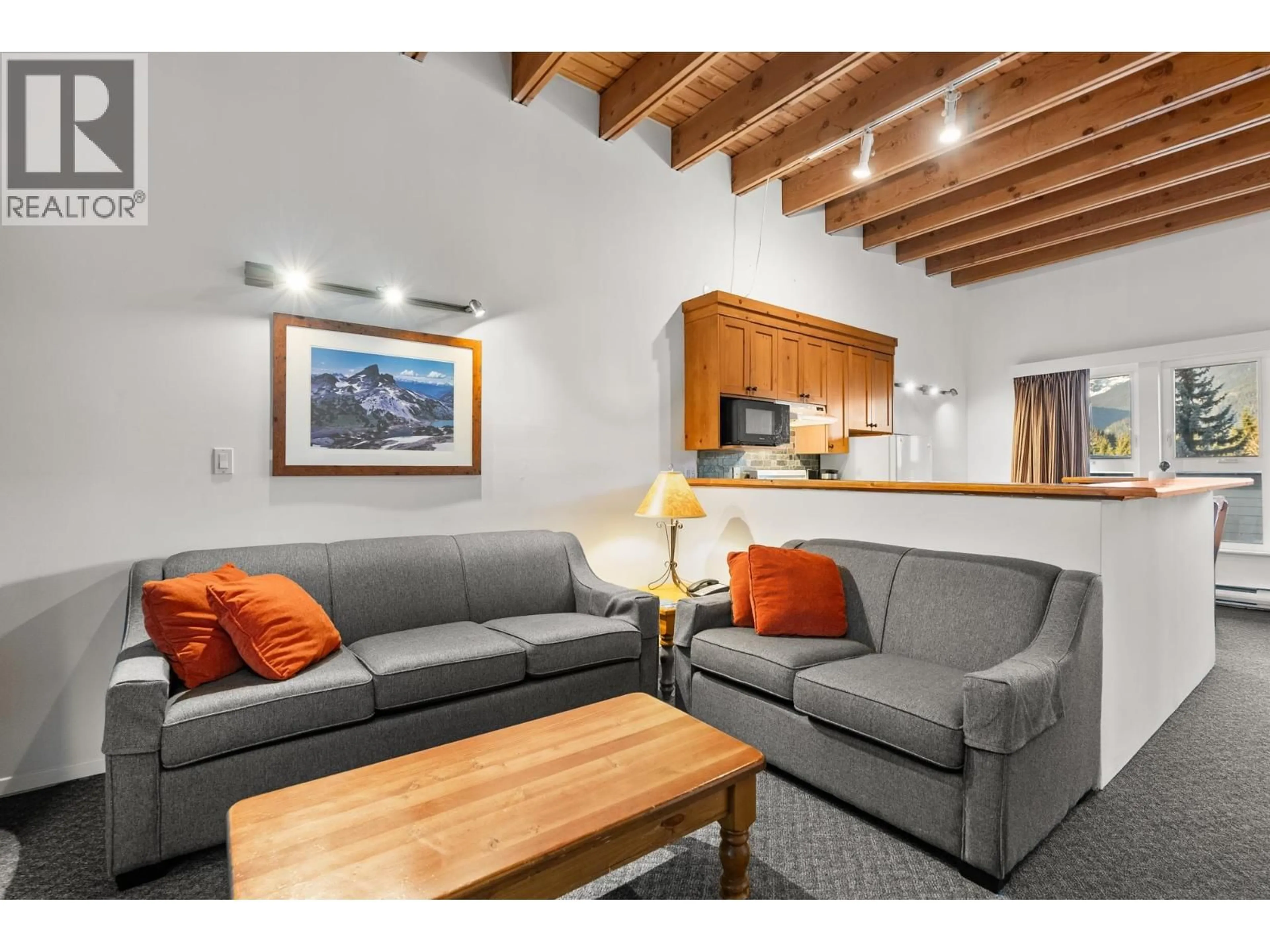 Living room with furniture, wood/laminate floor for 513 - 4200 WHISTLER WAY, Whistler British Columbia V8E1J4