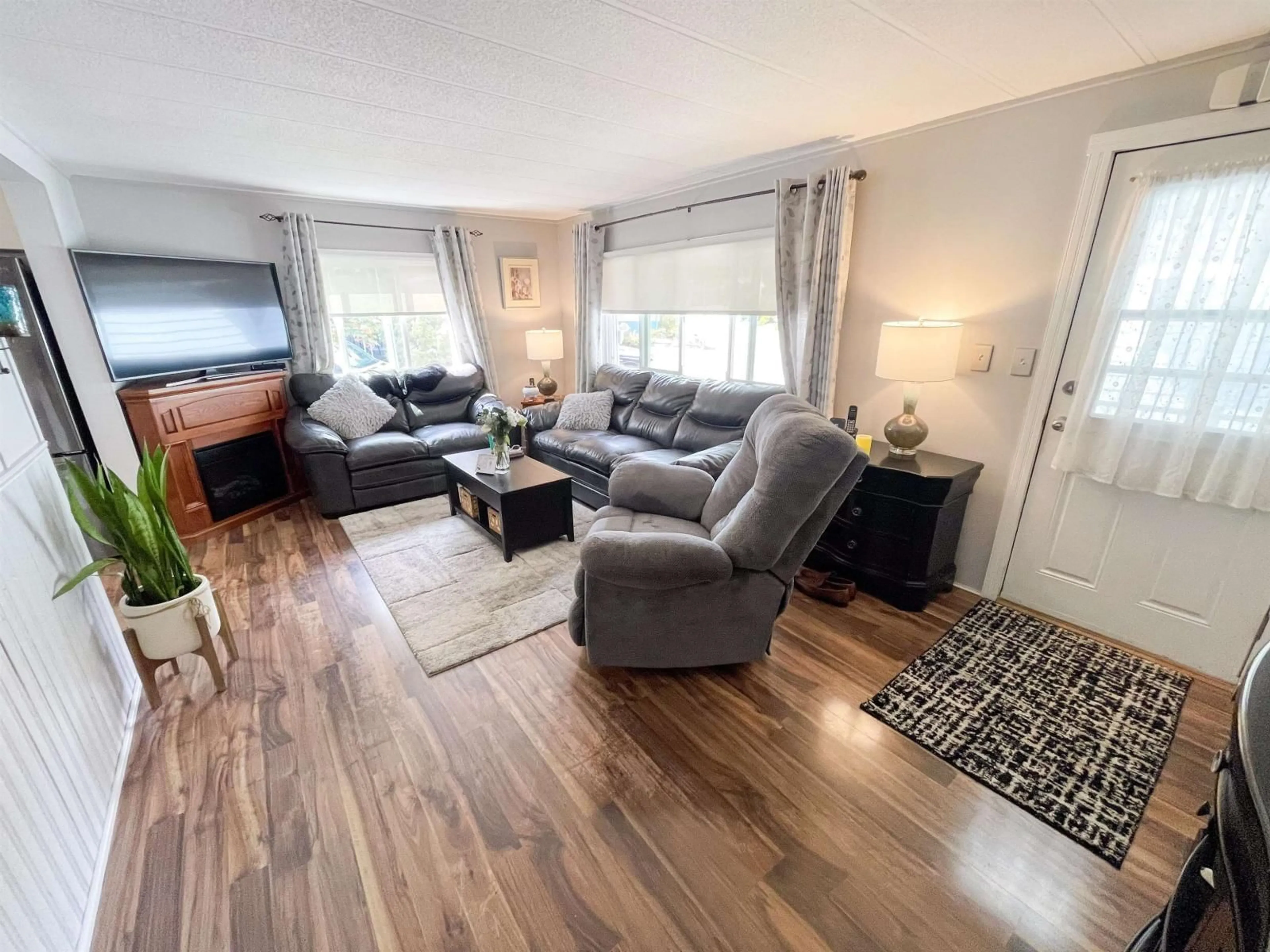 Living room with furniture, wood/laminate floor for 305 - 1840 160, Surrey British Columbia V4A4X4