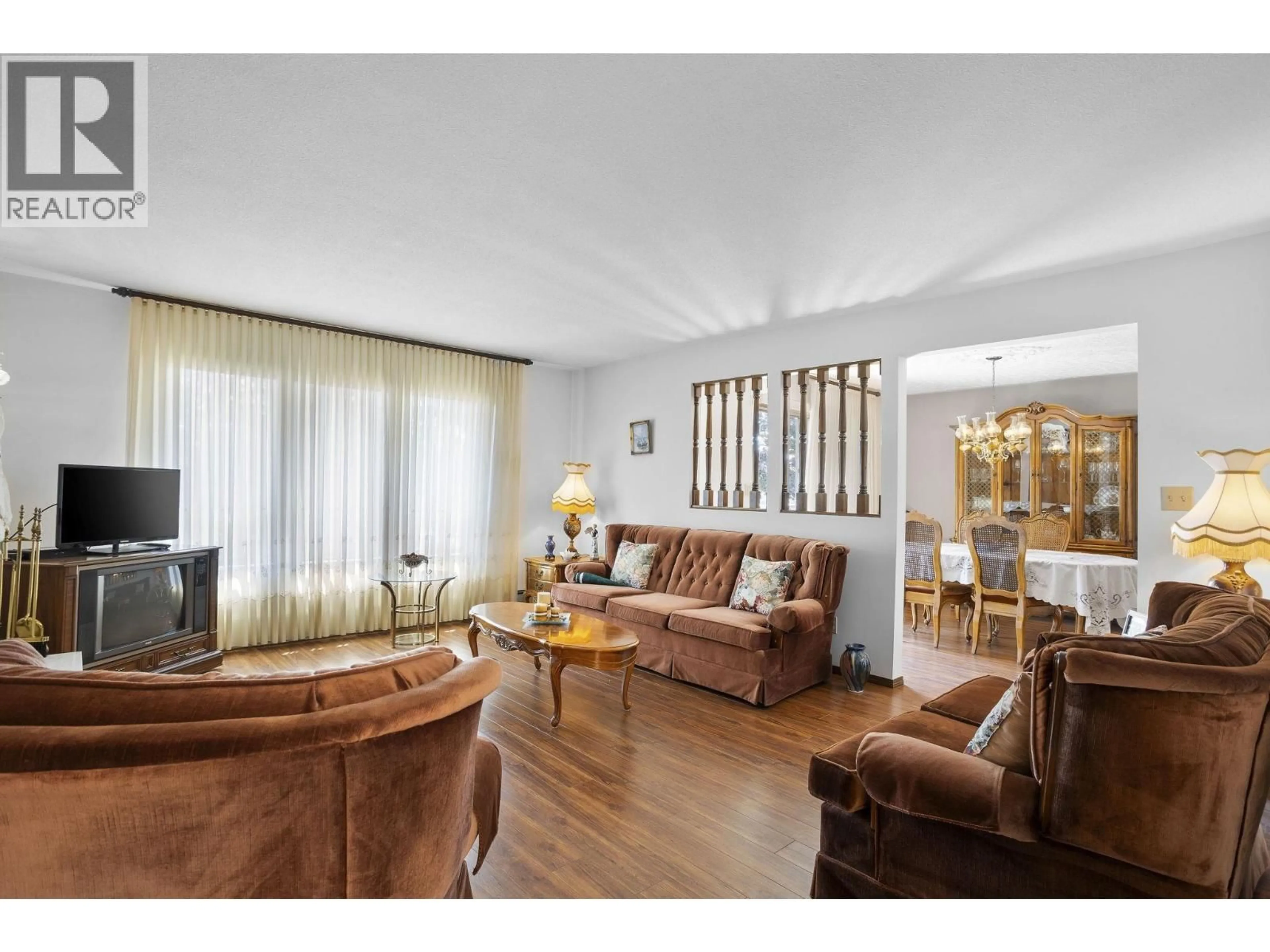 Living room with furniture, wood/laminate floor for 7321 UNION STREET, Burnaby British Columbia V5A1J1