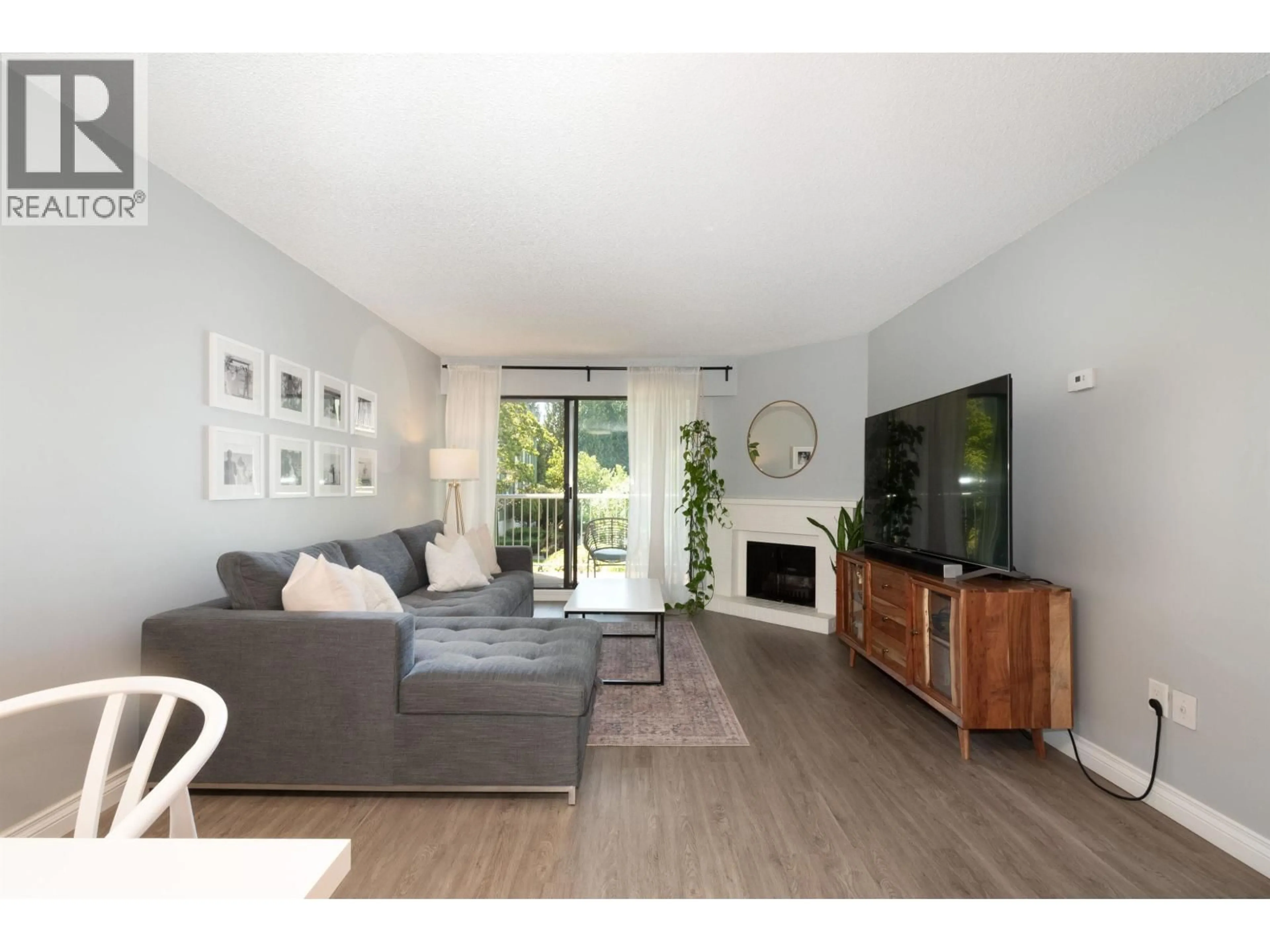 Living room with furniture, wood/laminate floor for 207 - 9202 HORNE STREET, Burnaby British Columbia V3N4K2