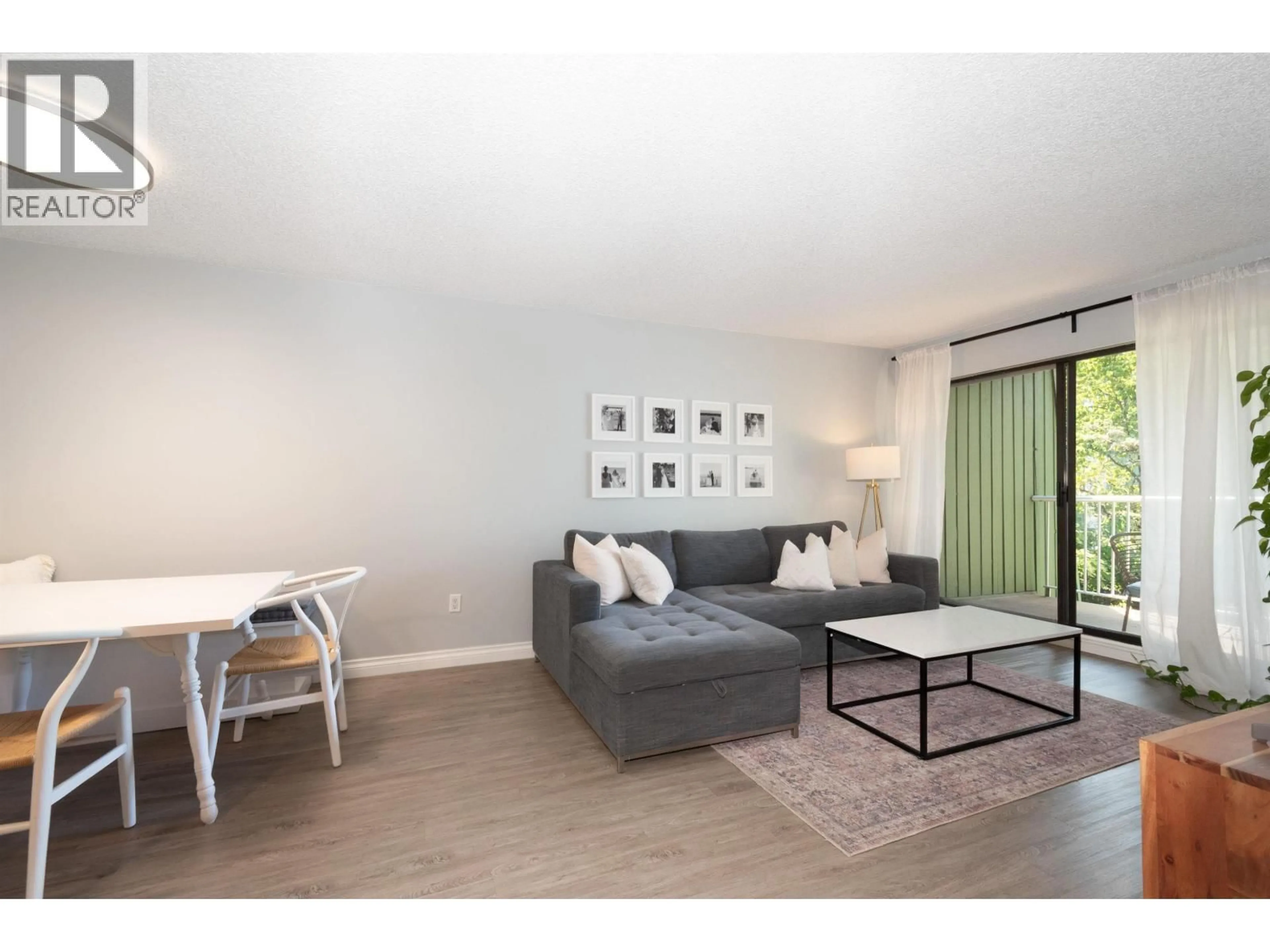 Living room with furniture, wood/laminate floor for 207 - 9202 HORNE STREET, Burnaby British Columbia V3N4K2