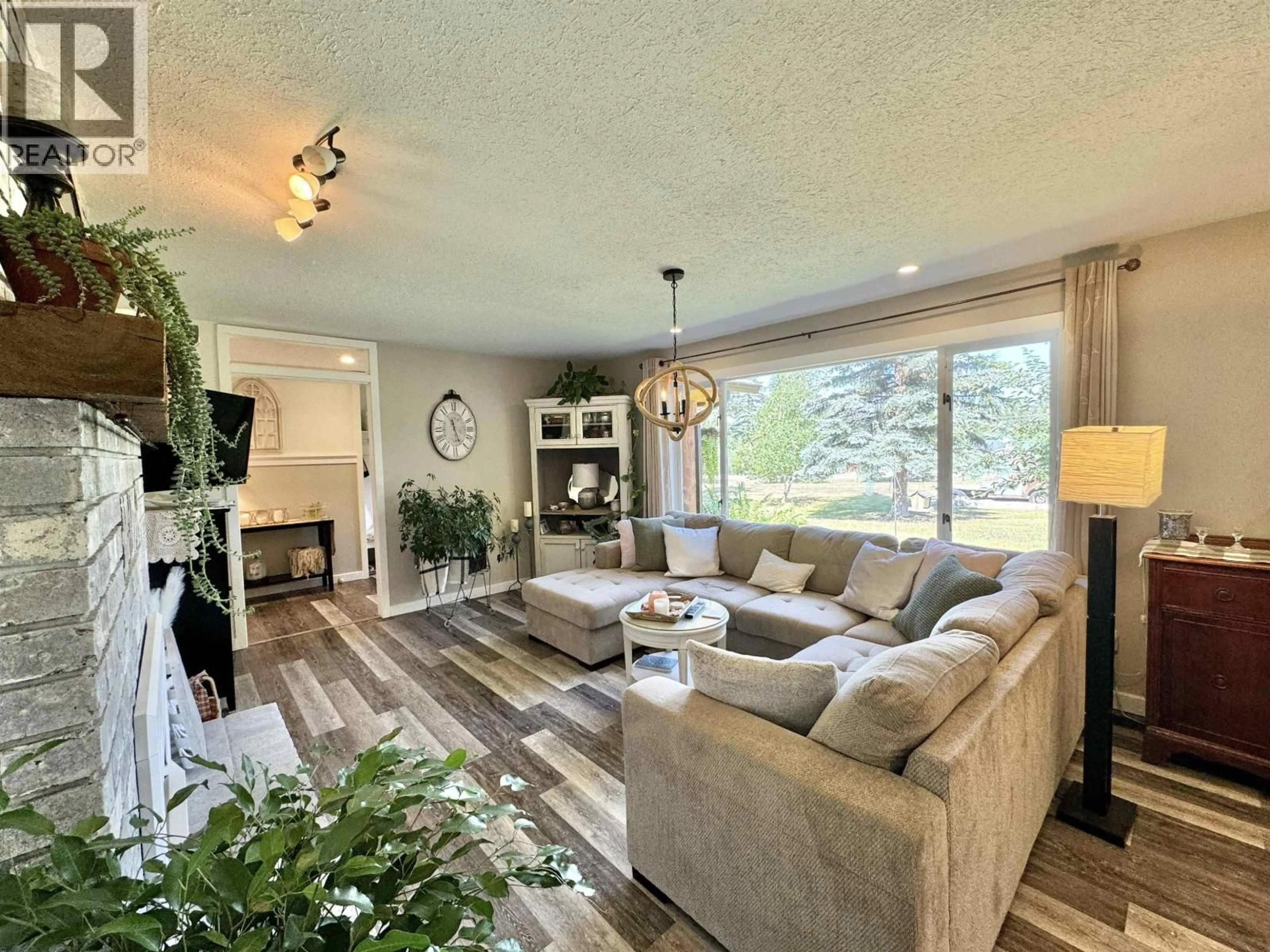 Living room with furniture, wood/laminate floor for 3278 EAGLE WAY, 150 Mile House British Columbia V0K2G0
