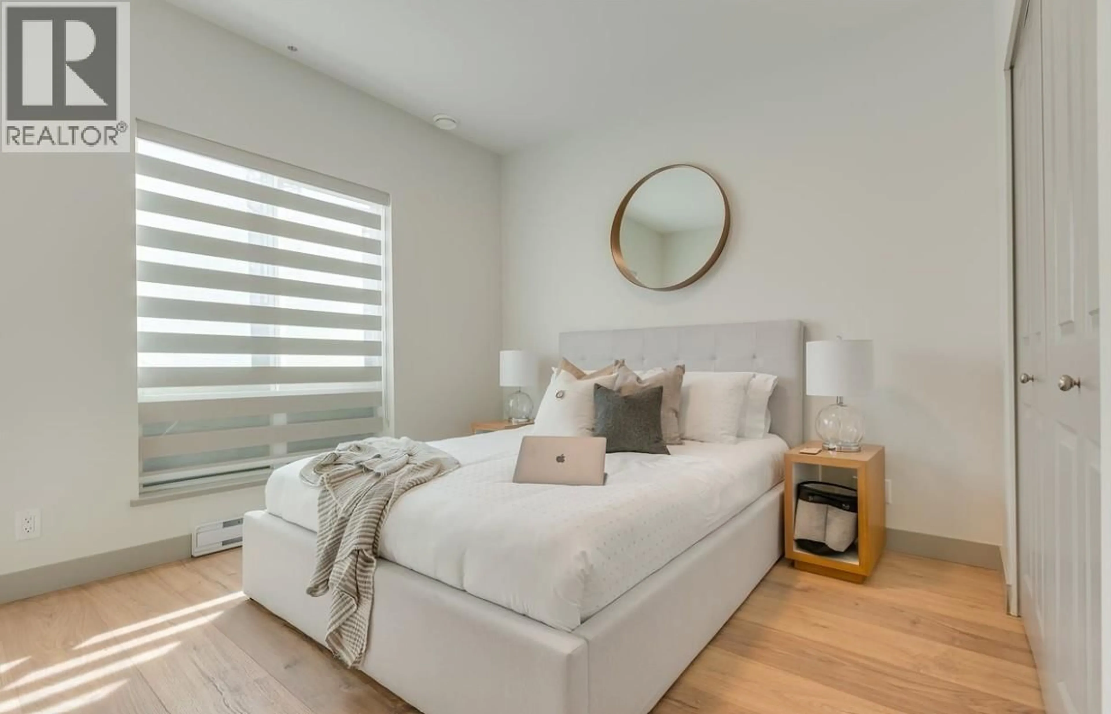 Bedroom with bed, wood/laminate floor for 211 - 6968 ROYAL OAK AVENUE, Burnaby British Columbia V5J4J3