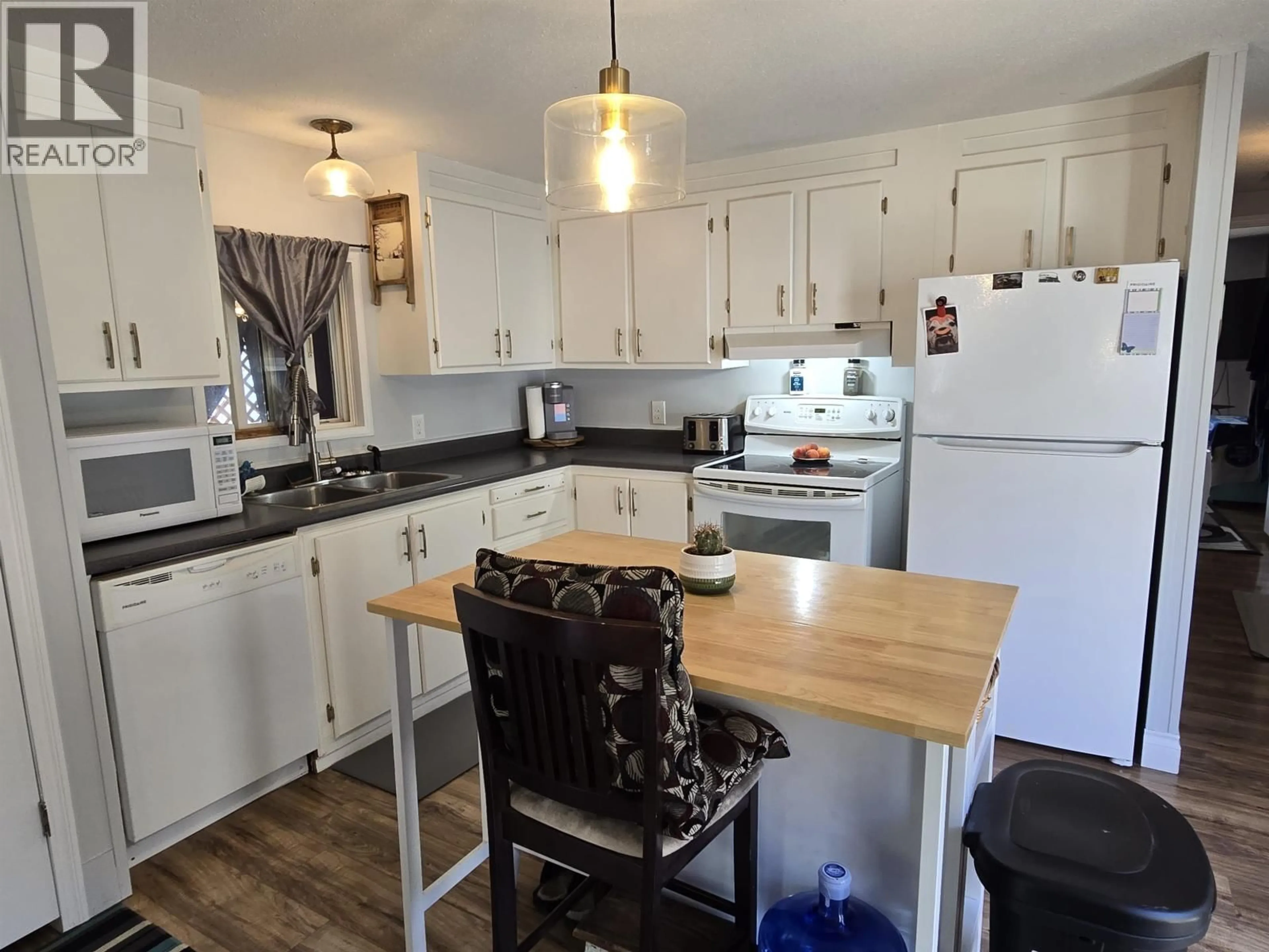 Open concept kitchen, wood/laminate floor for 10 - 3211 GOOK ROAD, Quesnel British Columbia V2J6N6