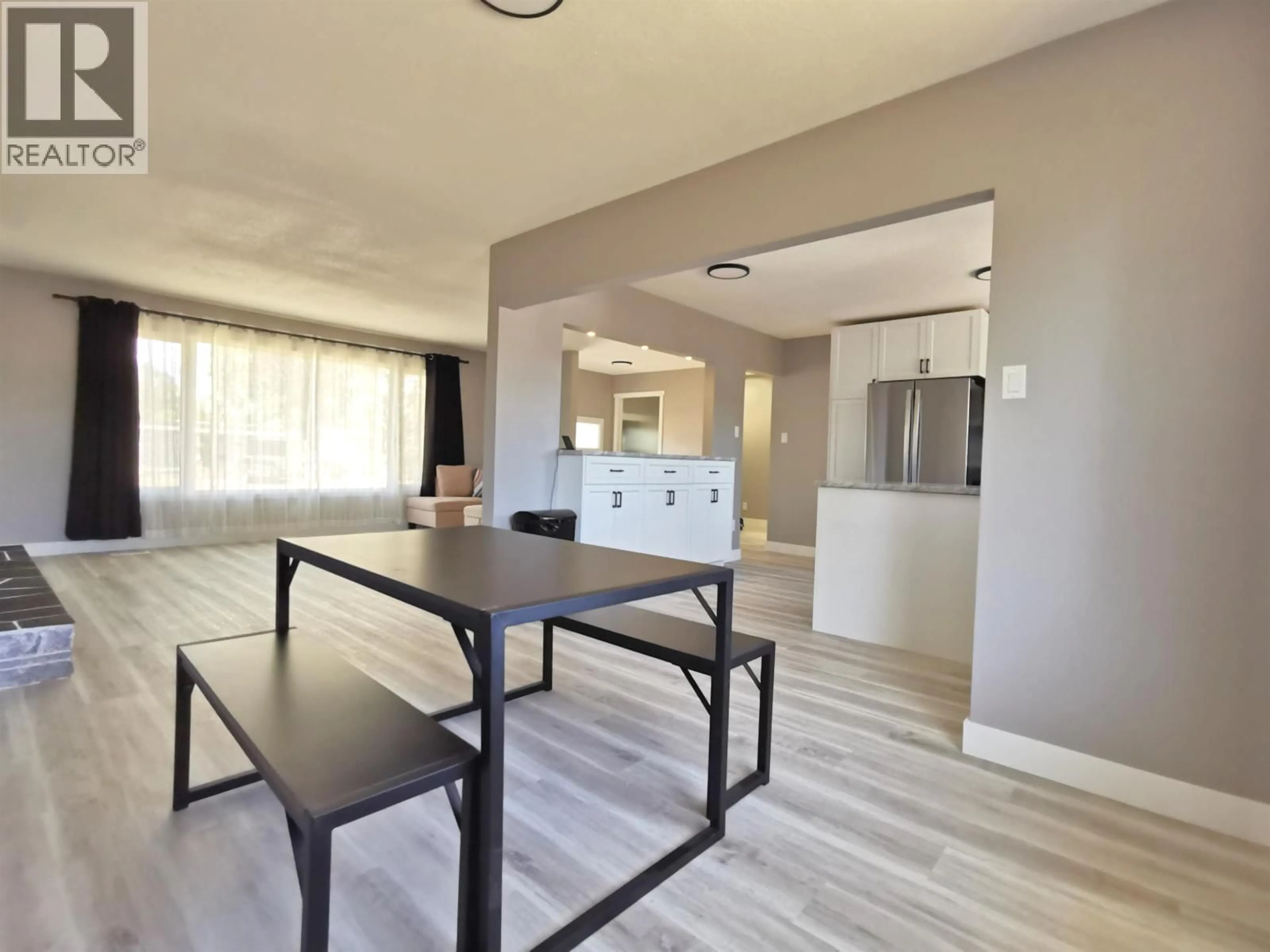 Open concept kitchen, wood/laminate floor for 1242 CARNEY STREET, Prince George British Columbia V2M2L2