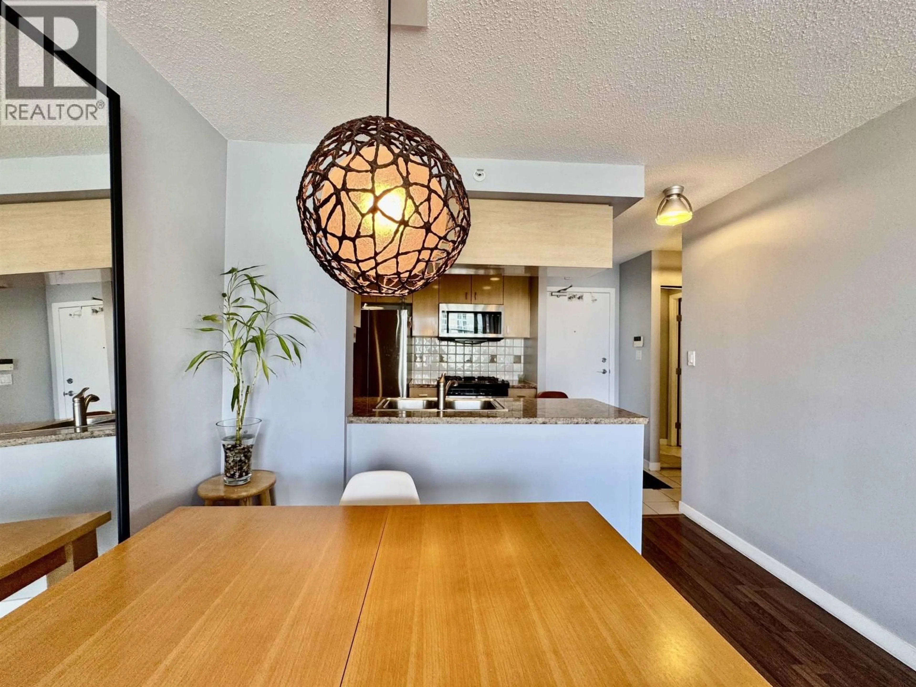 Open concept kitchen, wood/laminate floor for 3202 - 1033 MARINASIDE CRESCENT, Vancouver British Columbia V6Z3A3