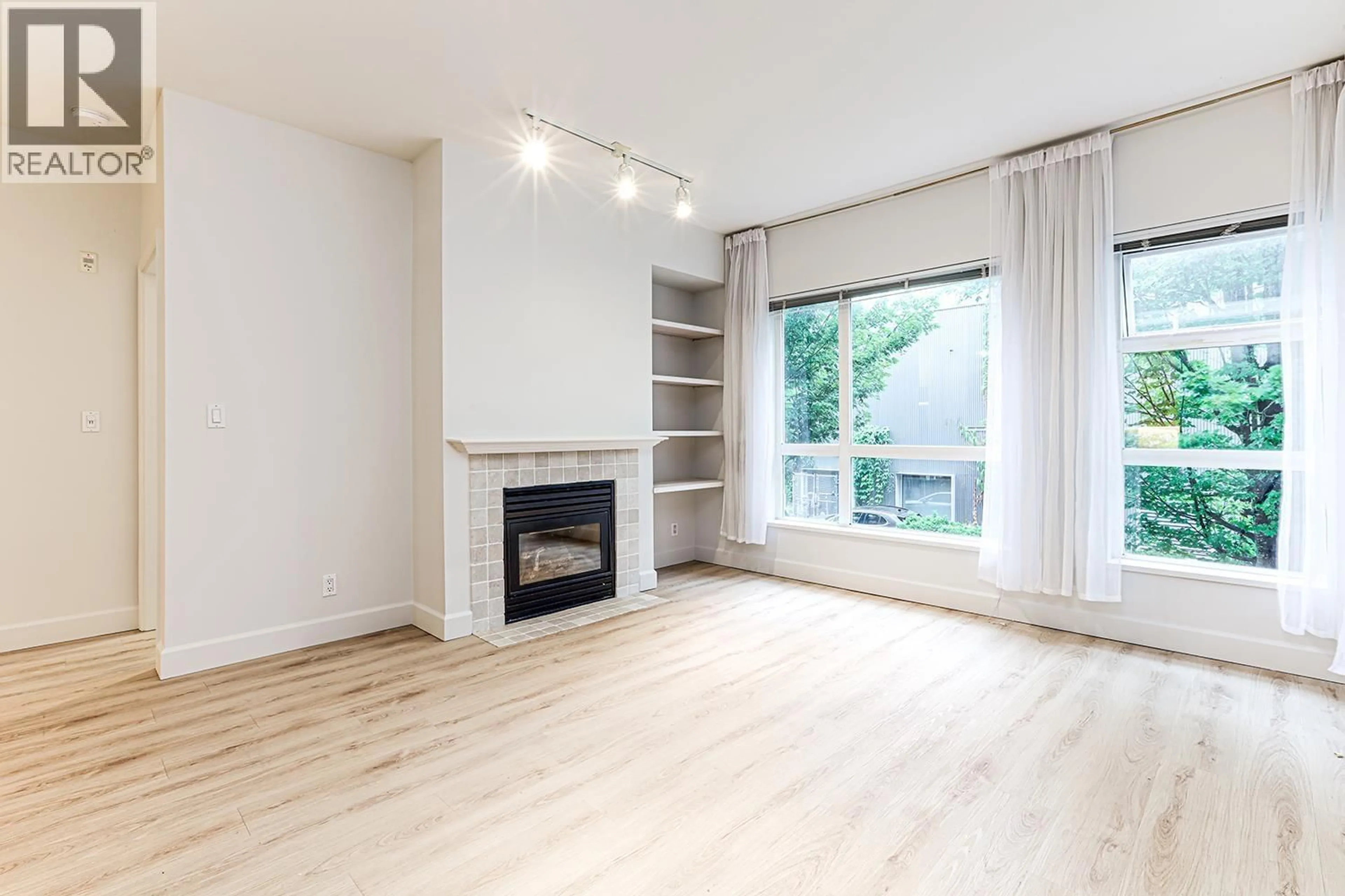 Living room with furniture, wood/laminate floor for 211 - 6198 ASH STREET, Vancouver British Columbia V5Z3G9