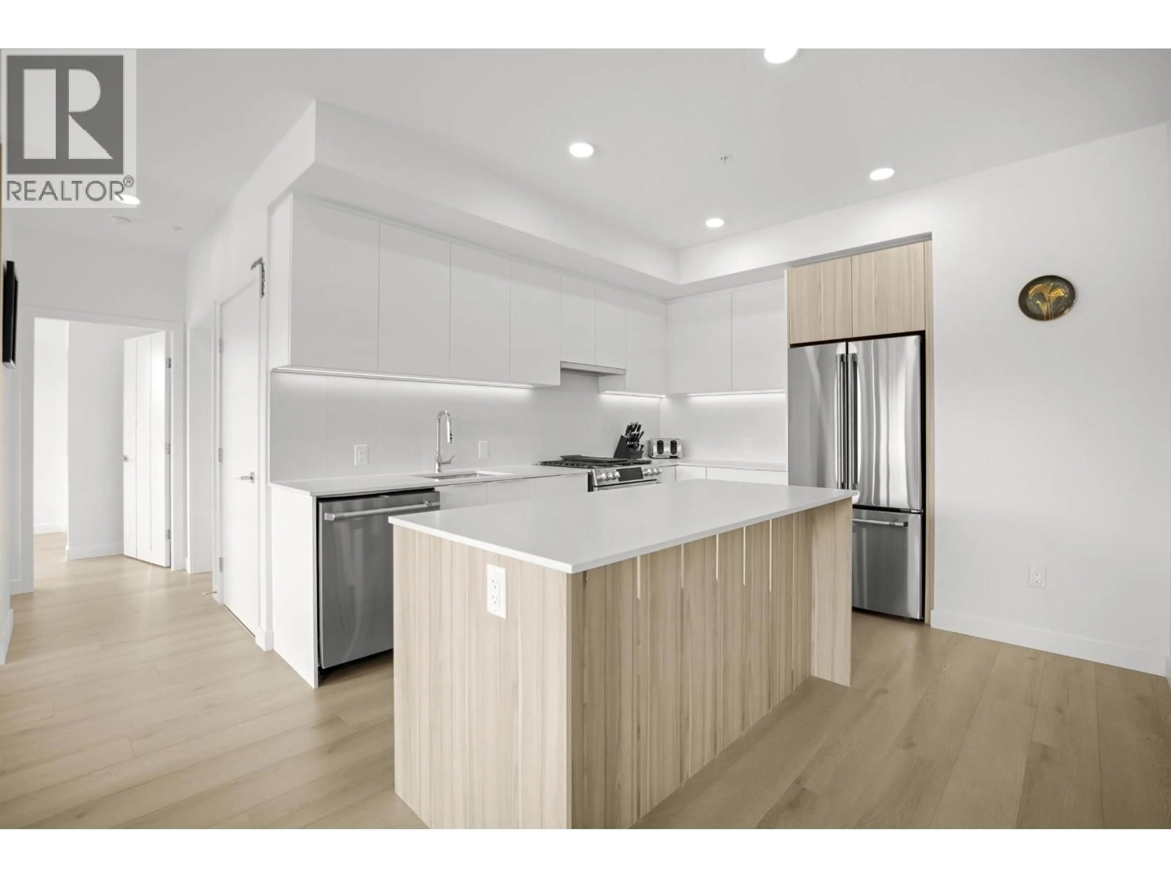 Open concept kitchen, wood/laminate floor for 505 - 2450 GARDEN DRIVE, Vancouver British Columbia V5N0K1