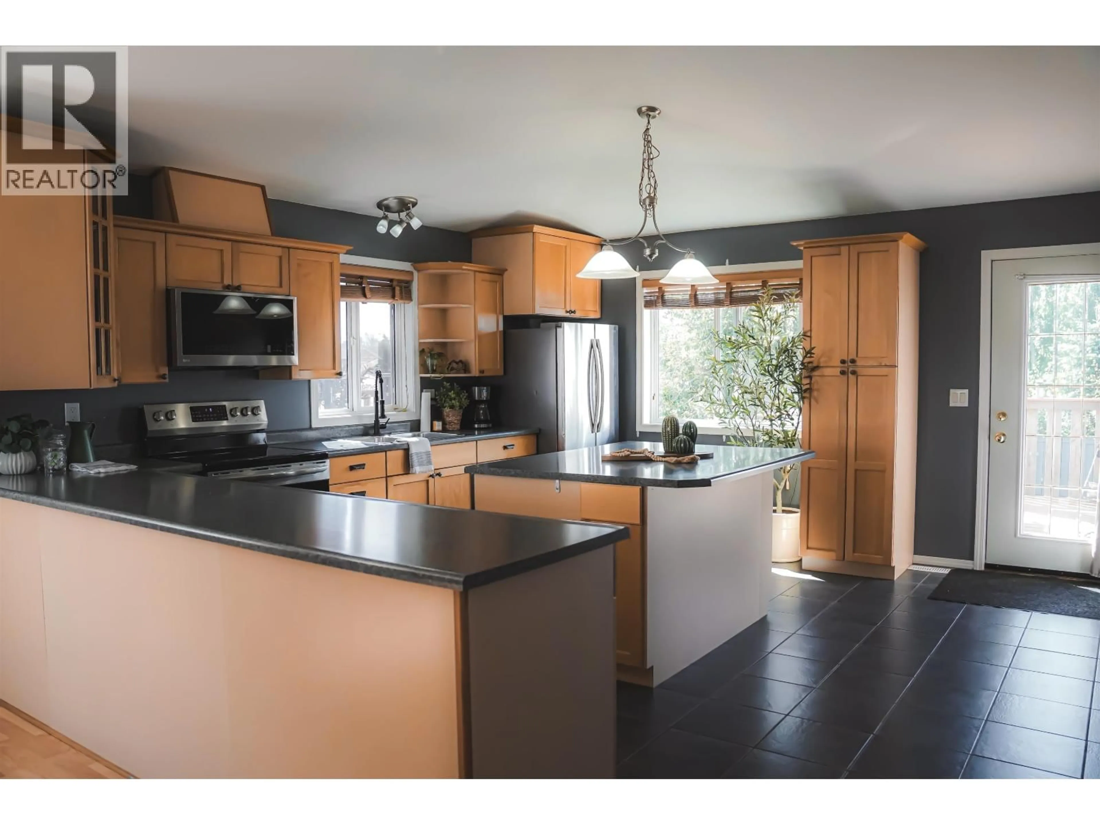 Open concept kitchen, wood/laminate floor for 8911 98 AVENUE, Fort St. John British Columbia V1J6Y7