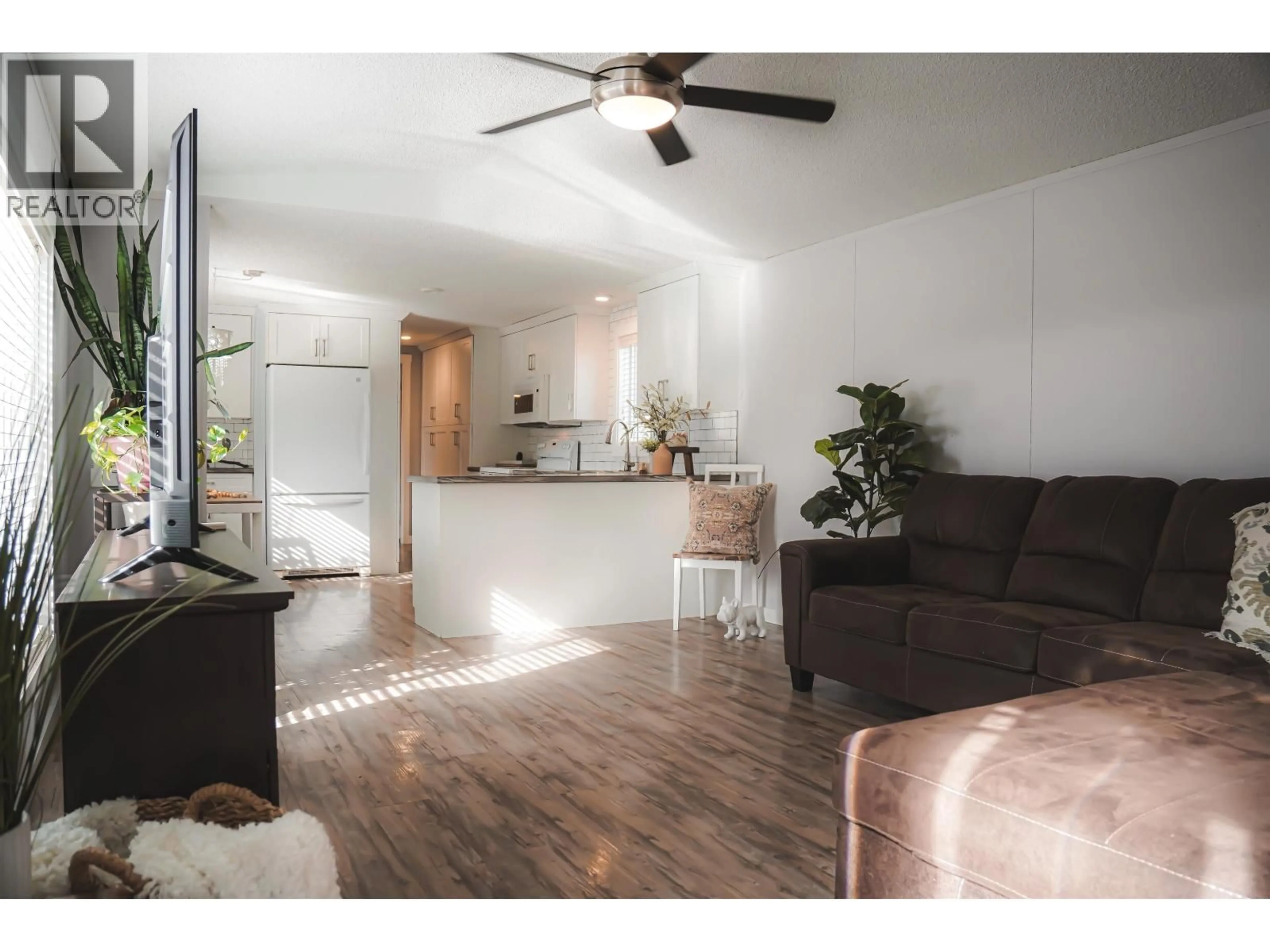 Living room with furniture, wood/laminate floor for 12478 RIMROCK DRIVE, Charlie Lake British Columbia V0C1H0