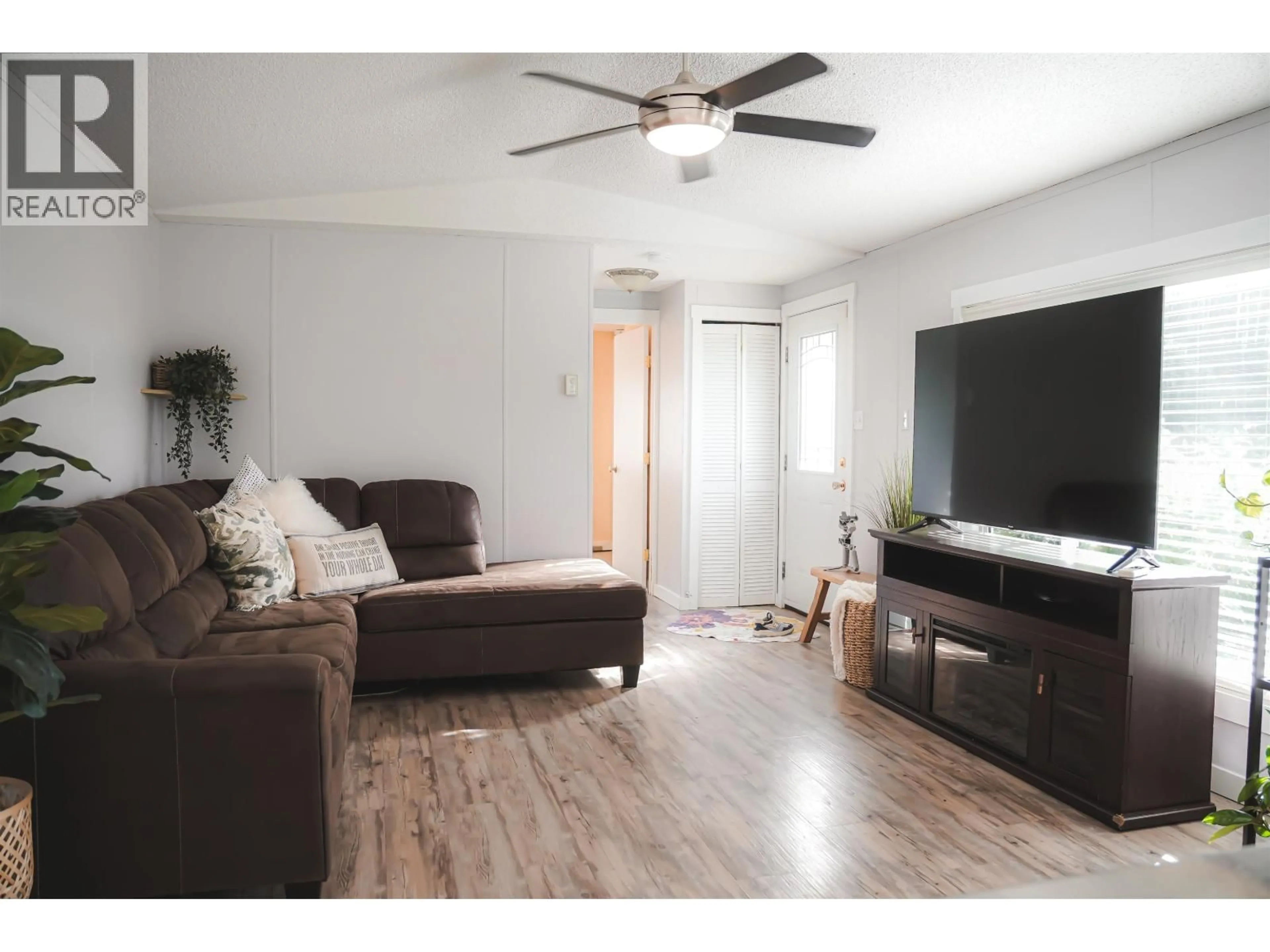 Living room with furniture, wood/laminate floor for 12478 RIMROCK DRIVE, Charlie Lake British Columbia V0C1H0