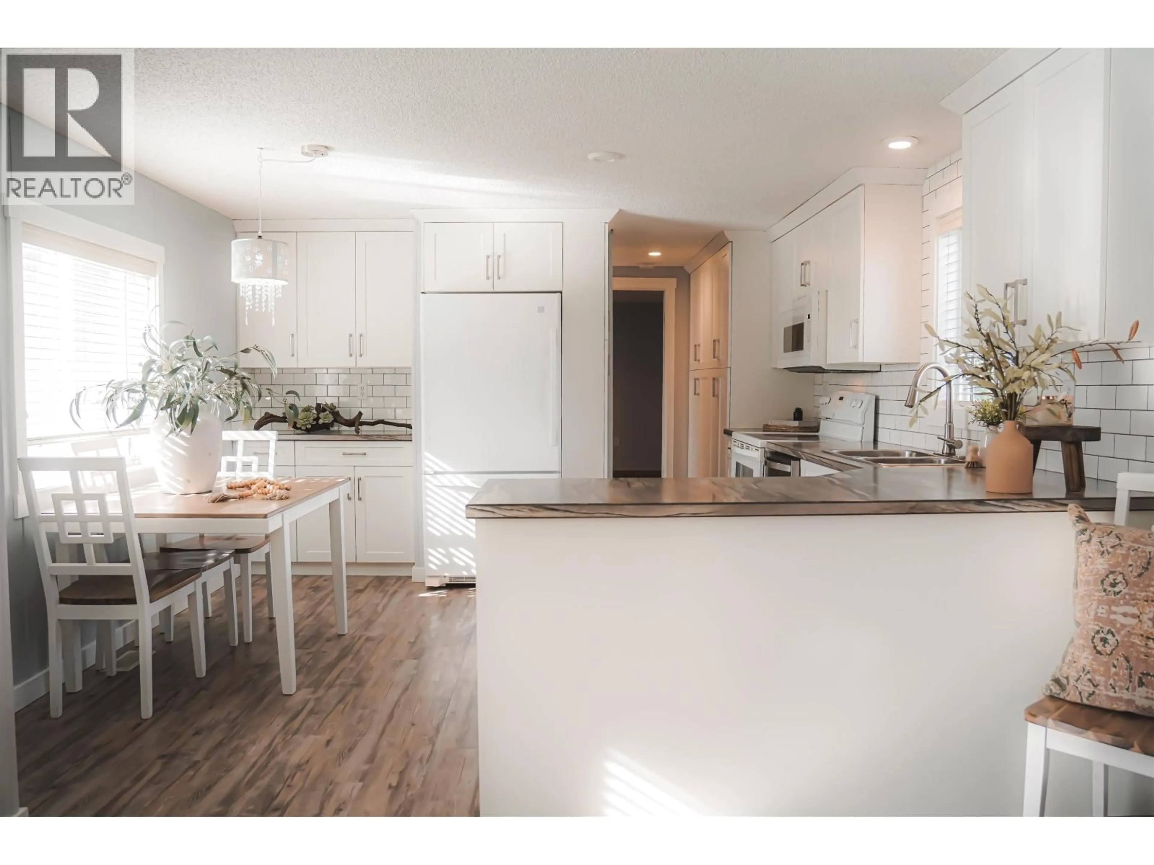 Open concept kitchen, wood/laminate floor for 12478 RIMROCK DRIVE, Charlie Lake British Columbia V0C1H0