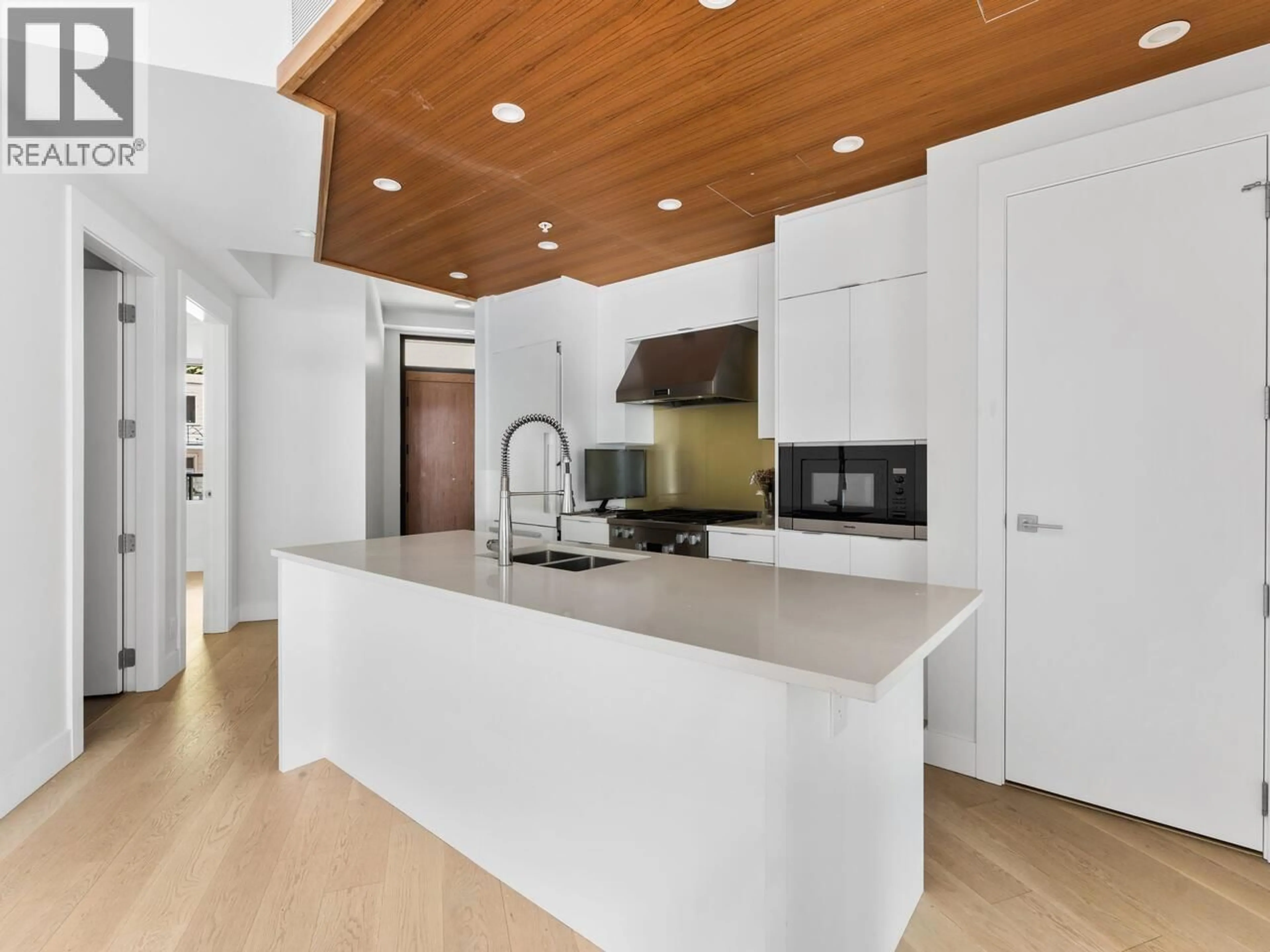 Contemporary kitchen, wood/laminate floor for 405 - 6687 NELSON AVENUE, West Vancouver British Columbia V7W2B2