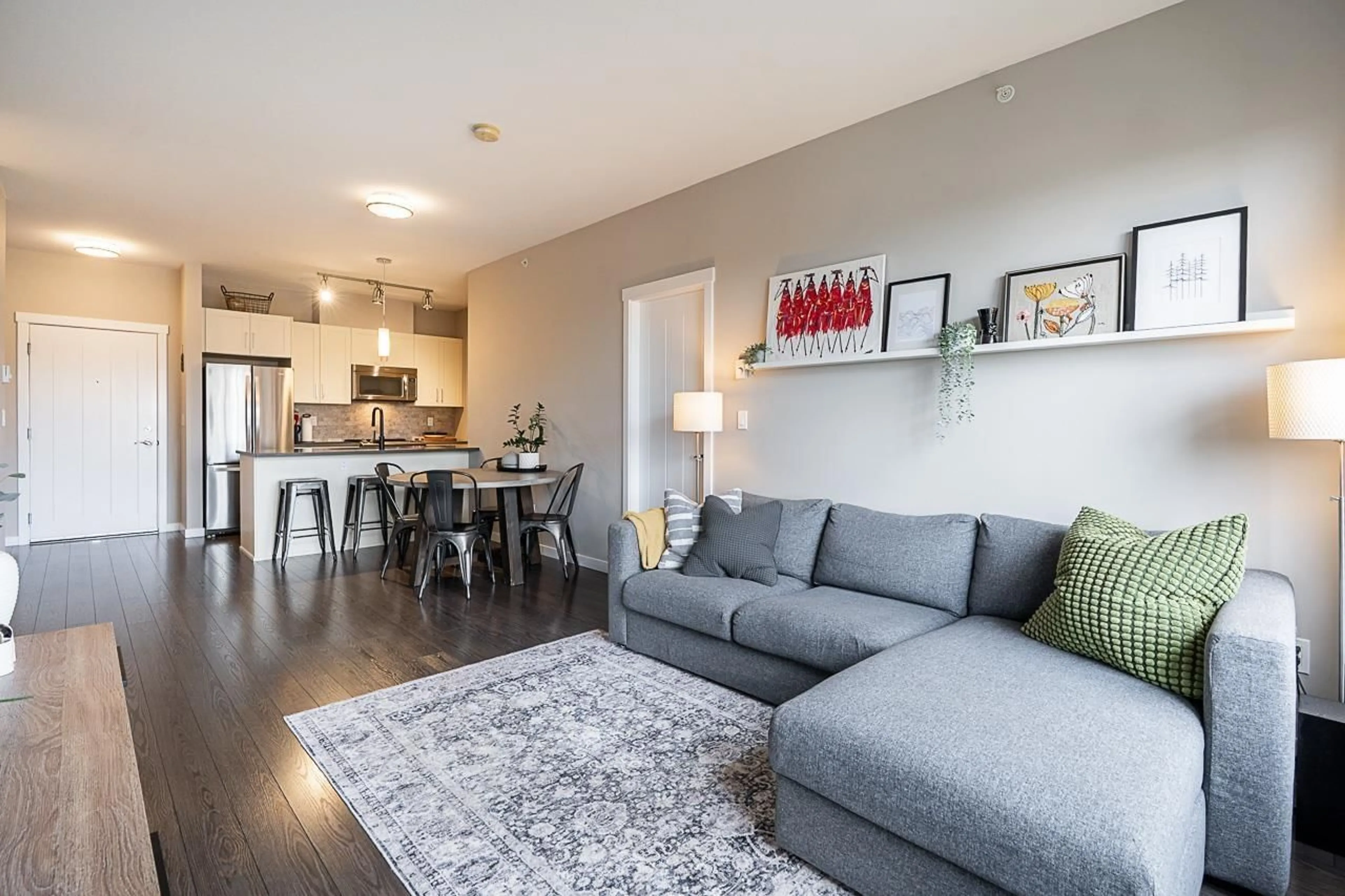 Living room with furniture, wood/laminate floor for 306 - 2855 156, Surrey British Columbia V3Z3Y3