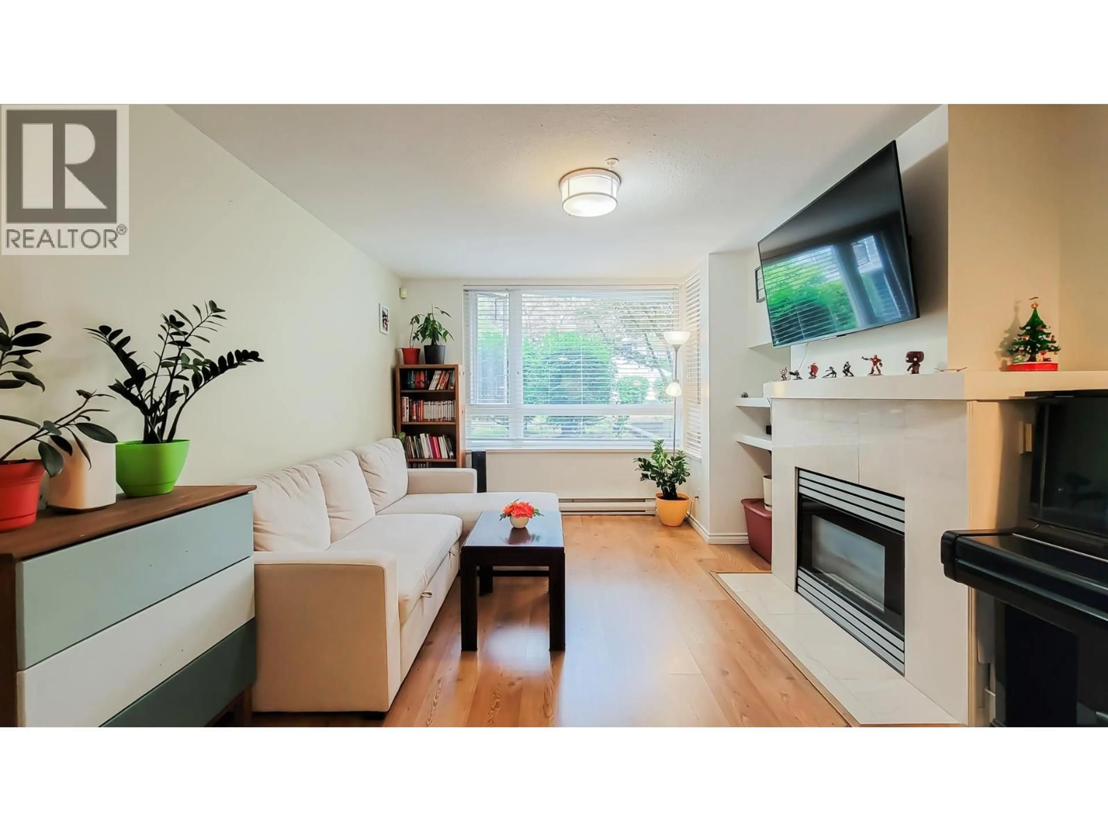 Living room with furniture, wood/laminate floor for 212 - 1163 THE HIGH STREET, Coquitlam British Columbia V3B7W2
