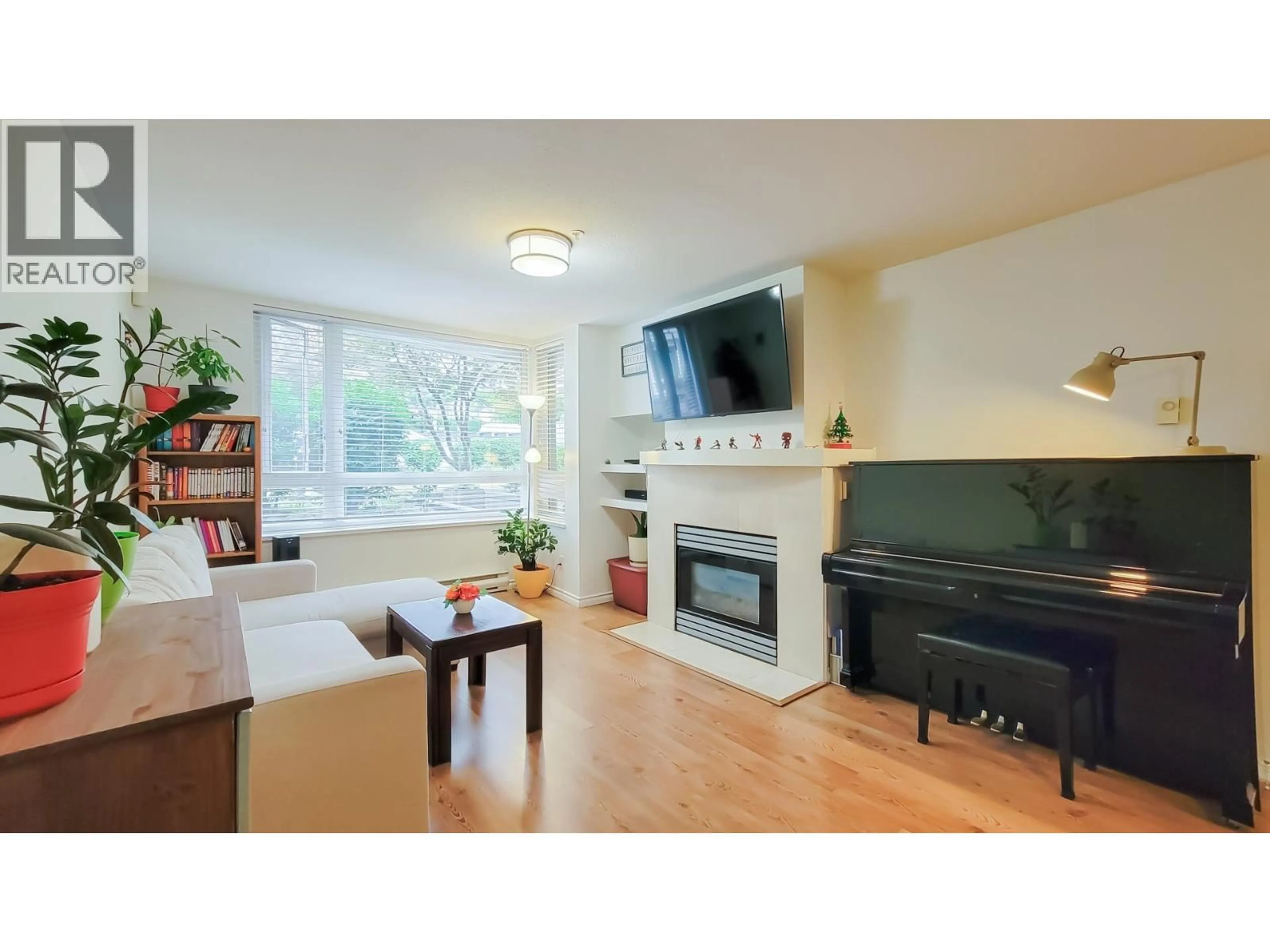 Living room with furniture, wood/laminate floor for 212 - 1163 THE HIGH STREET, Coquitlam British Columbia V3B7W2
