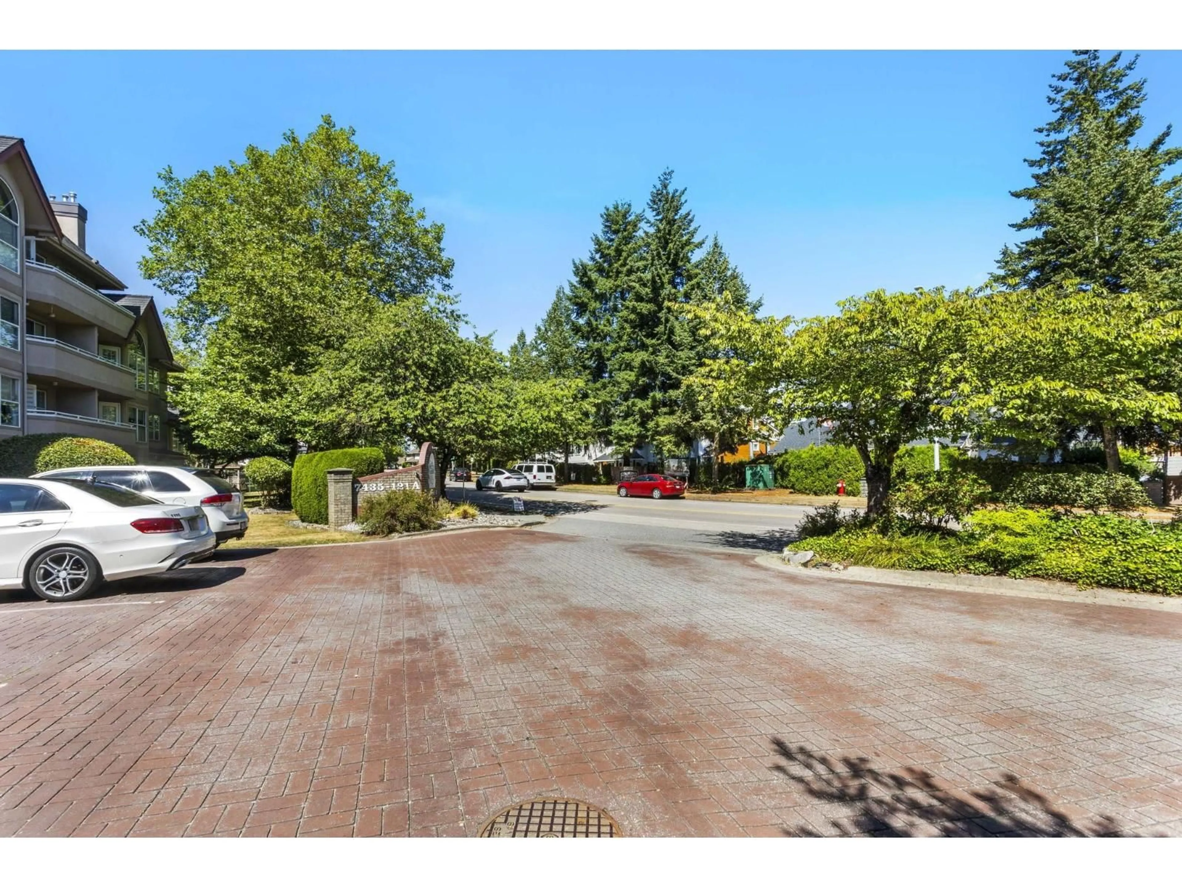 A pic from outside/outdoor area/front of a property/back of a property/a pic from drone, street for 310 - 7435 121A, Surrey British Columbia V3W0W8
