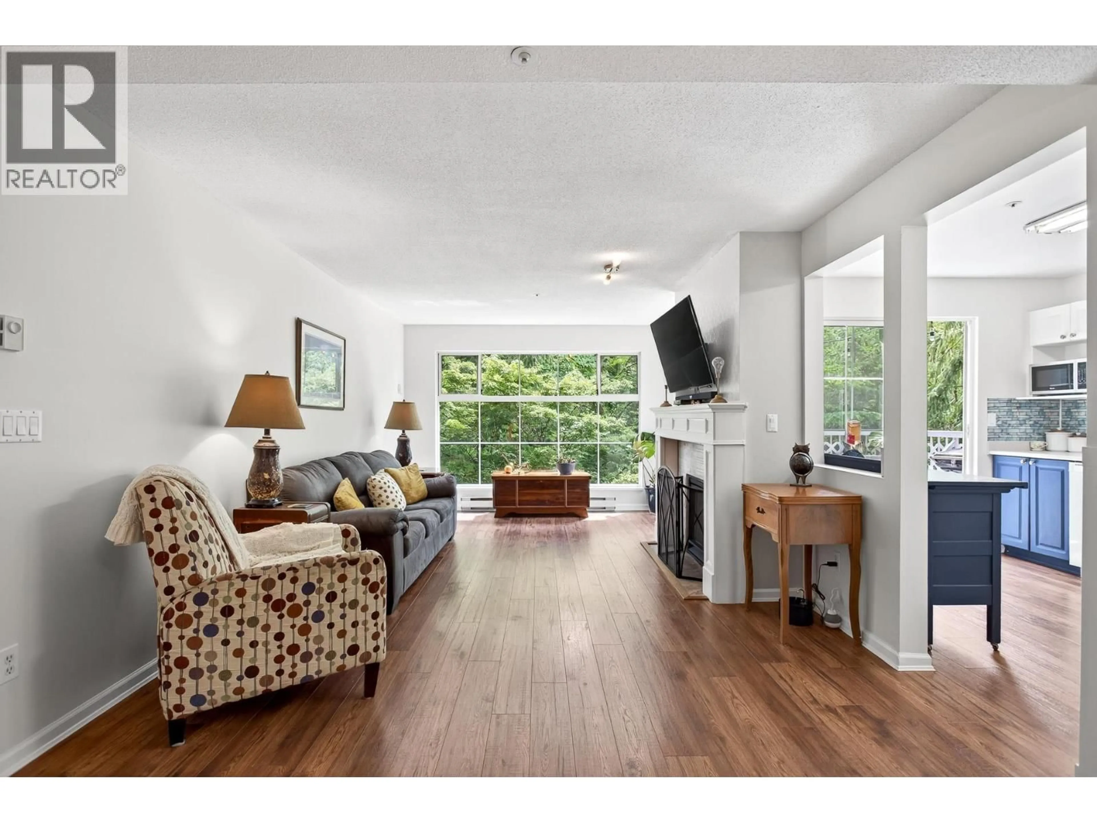 Living room with furniture, wood/laminate floor for 318 - 2678 DIXON STREET, Port Coquitlam British Columbia V3C6L7