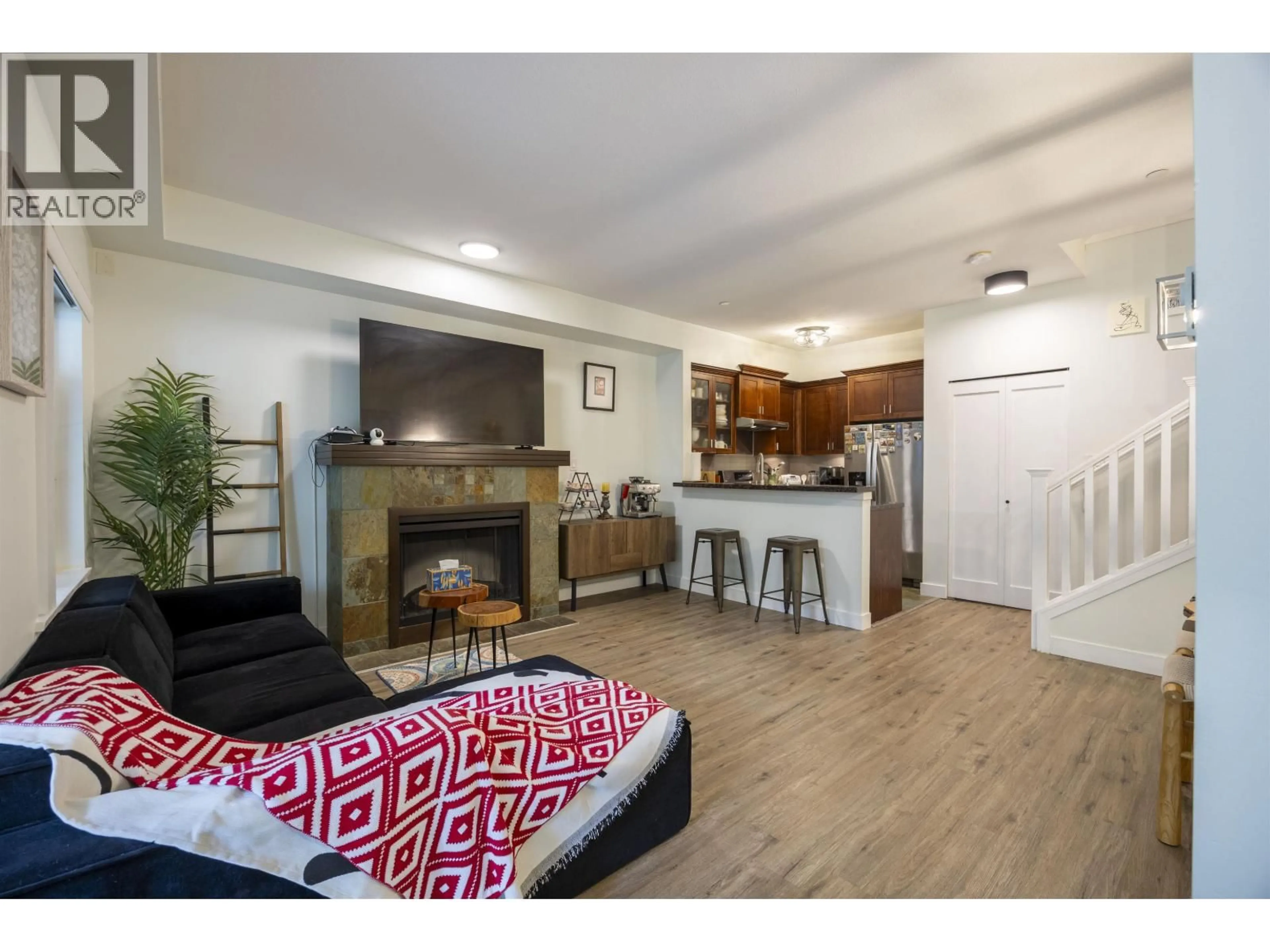 Living room with furniture, wood/laminate floor for 140 - 7388 MACPHERSON AVENUE, Burnaby British Columbia V5J0A1