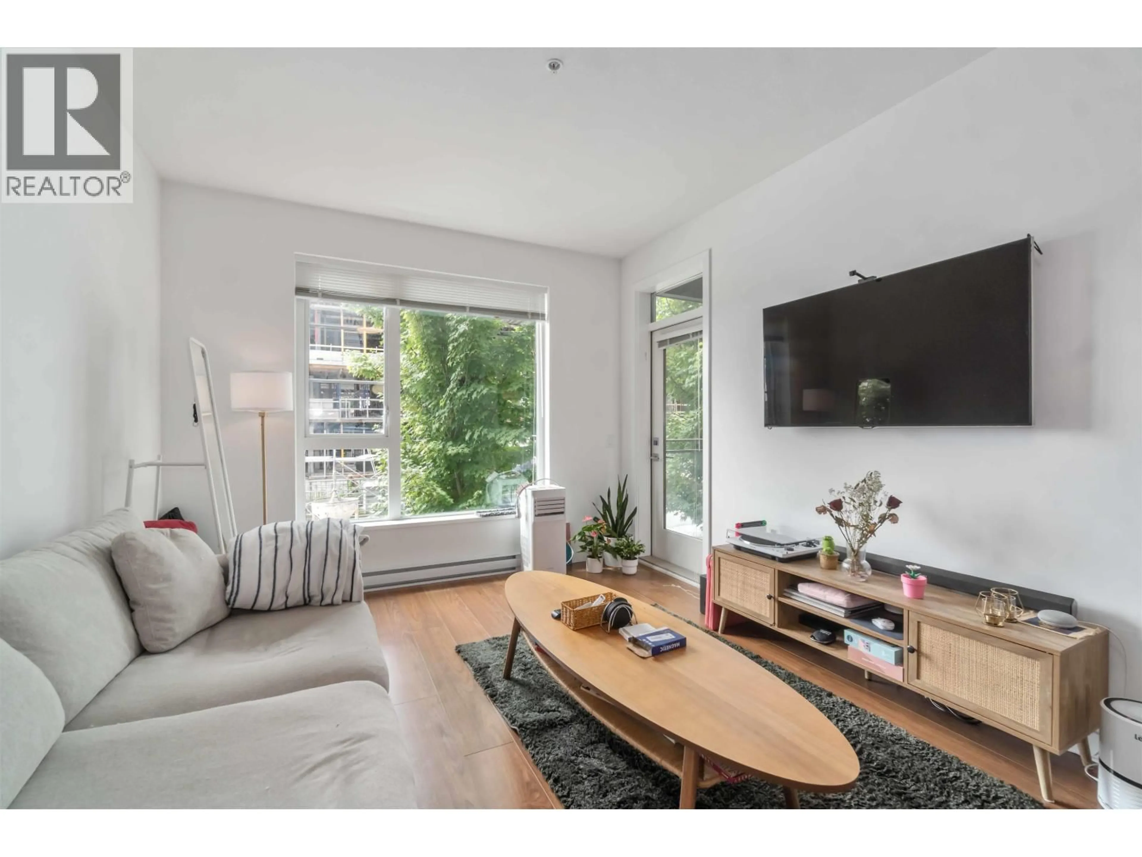 Living room with furniture, wood/laminate floor for 106 - 516 FOSTER AVENUE, Coquitlam British Columbia V3J0H8