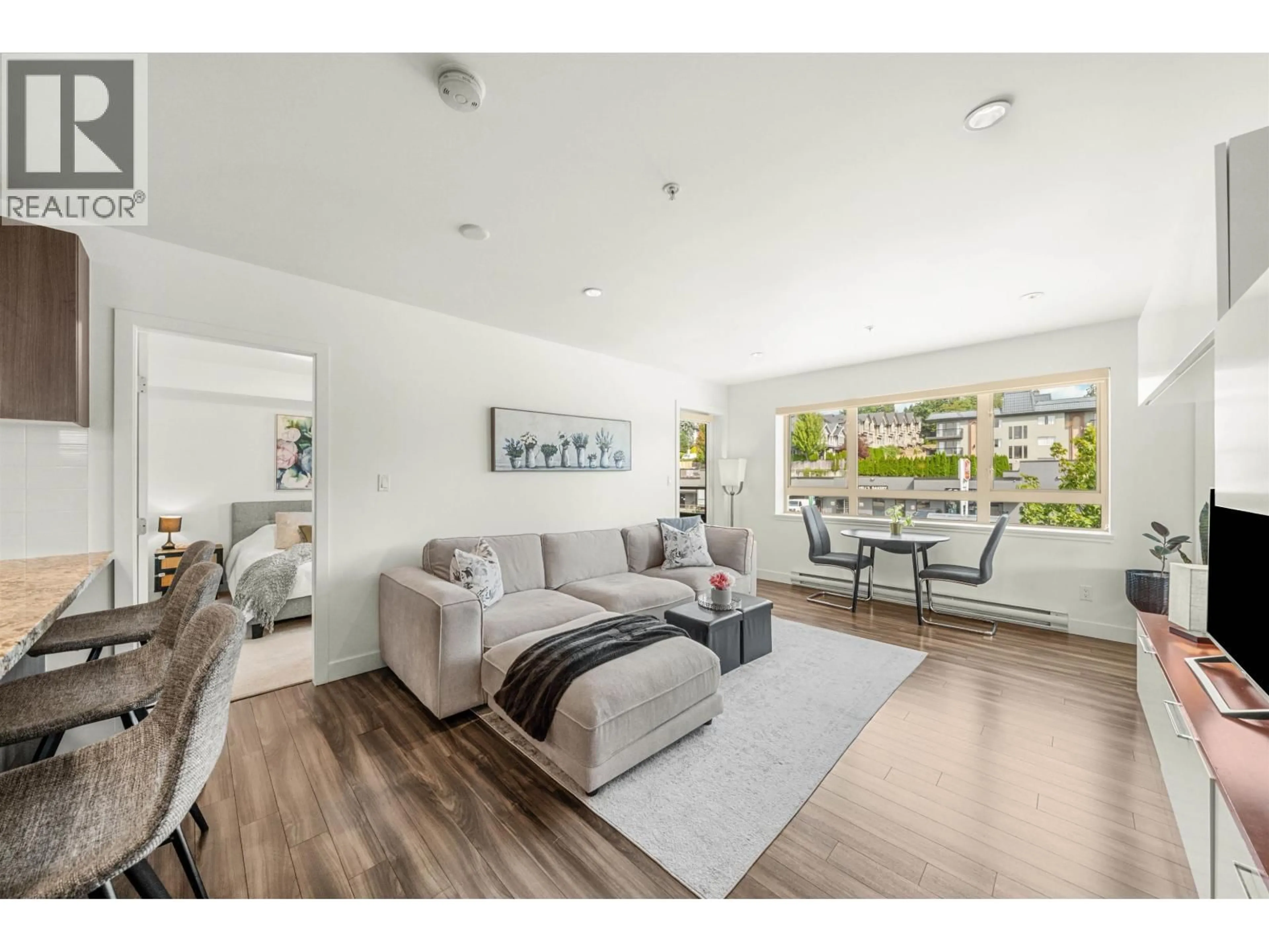 Living room with furniture, wood/laminate floor for 201 - 5688 HASTINGS STREET, Burnaby British Columbia V5B1R4