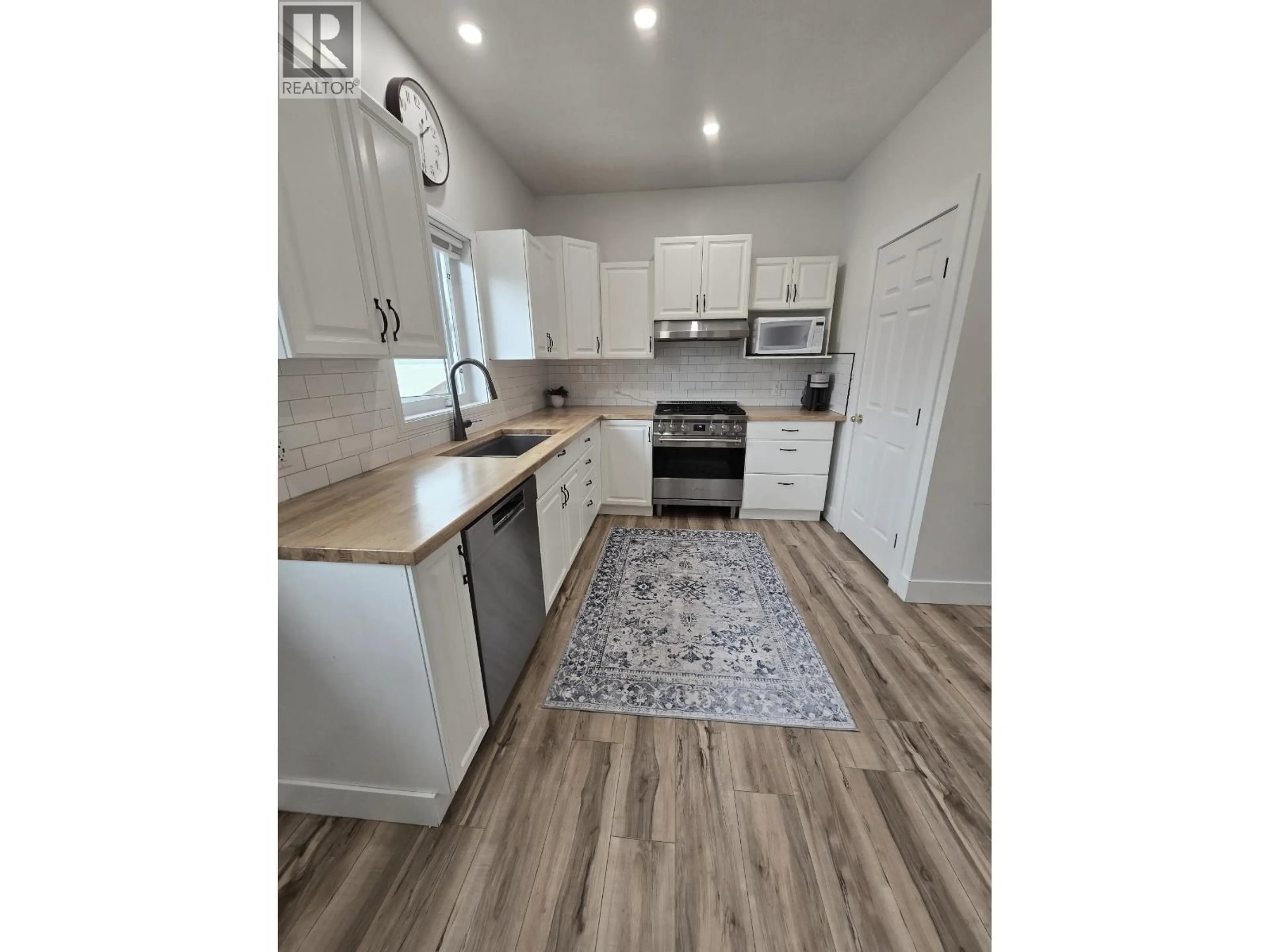Open concept kitchen, wood/laminate floor for 5203 LEBELL ROAD, Fort St. John British Columbia V1G0J4