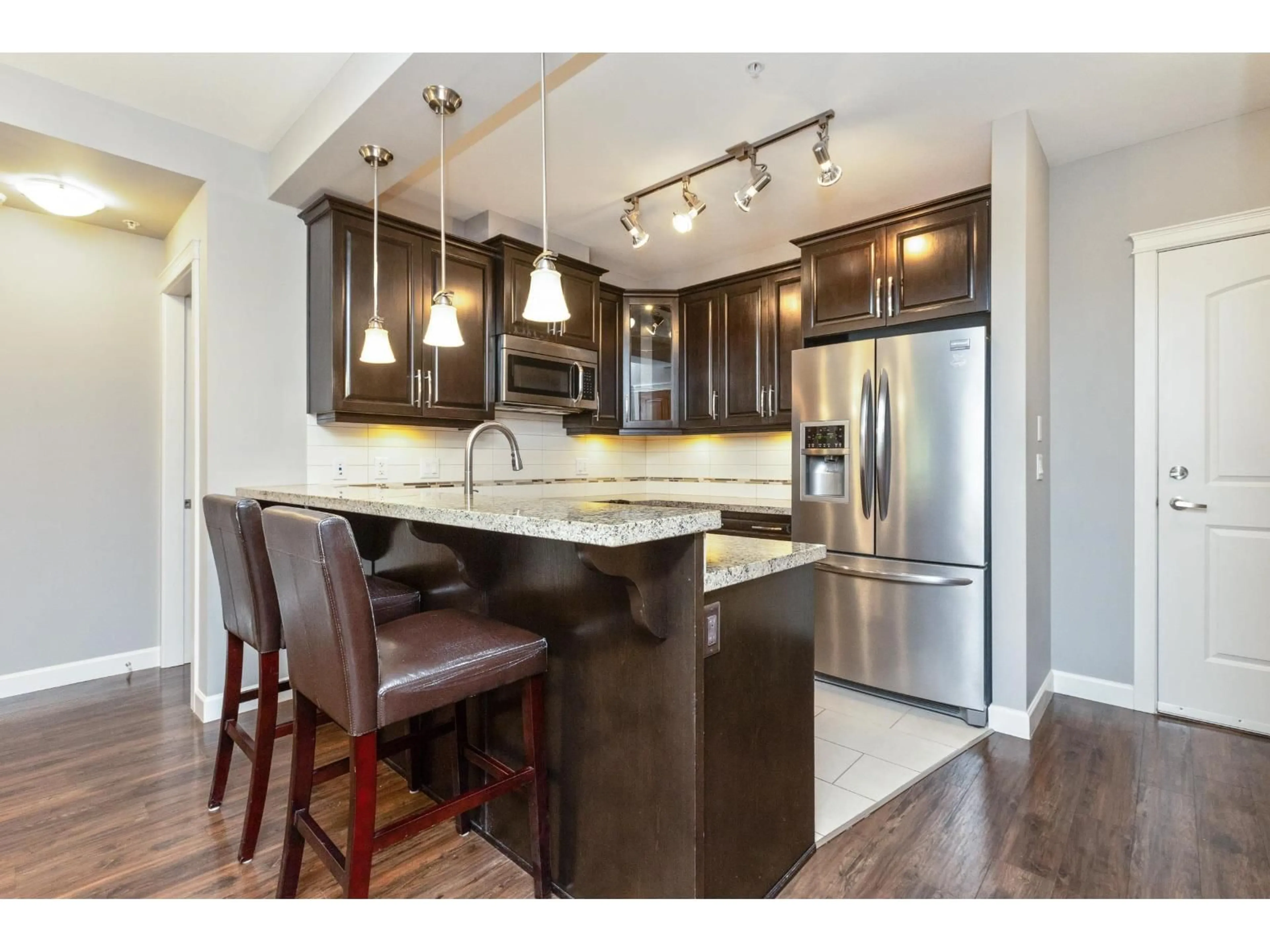 Open concept kitchen, wood/laminate floor for 429 - 8288 207A, Langley British Columbia V2Y0L2