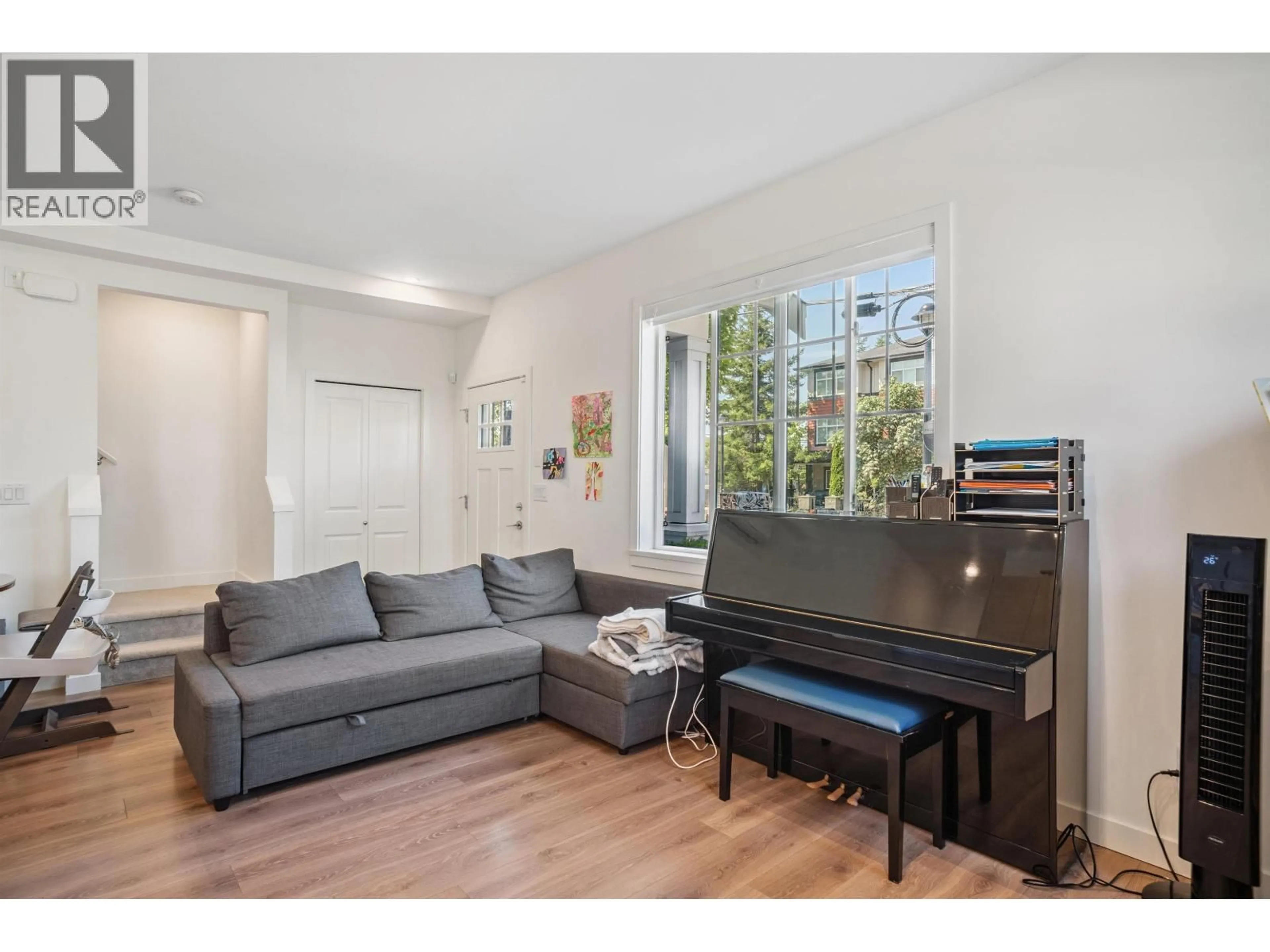 Living room with furniture, wood/laminate floor for 1 - 7780 BRIDGE STREET, Richmond British Columbia V6Y0L2