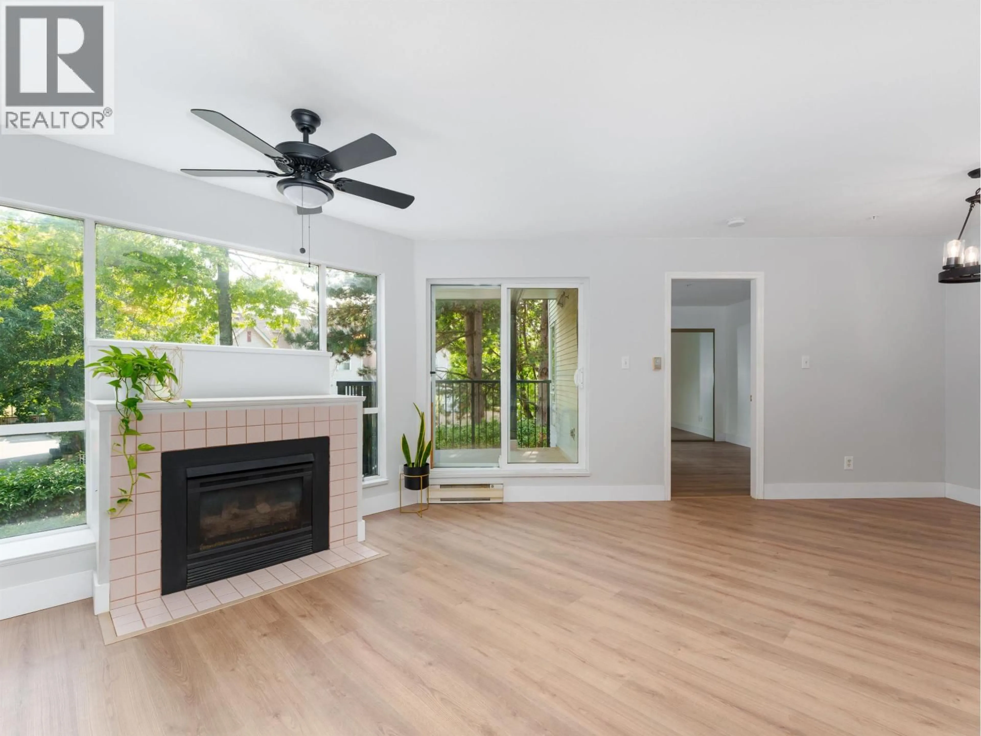 Living room with furniture, wood/laminate floor for 208 - 2429 HAWTHORNE AVENUE, Port Coquitlam British Columbia V3C6G6