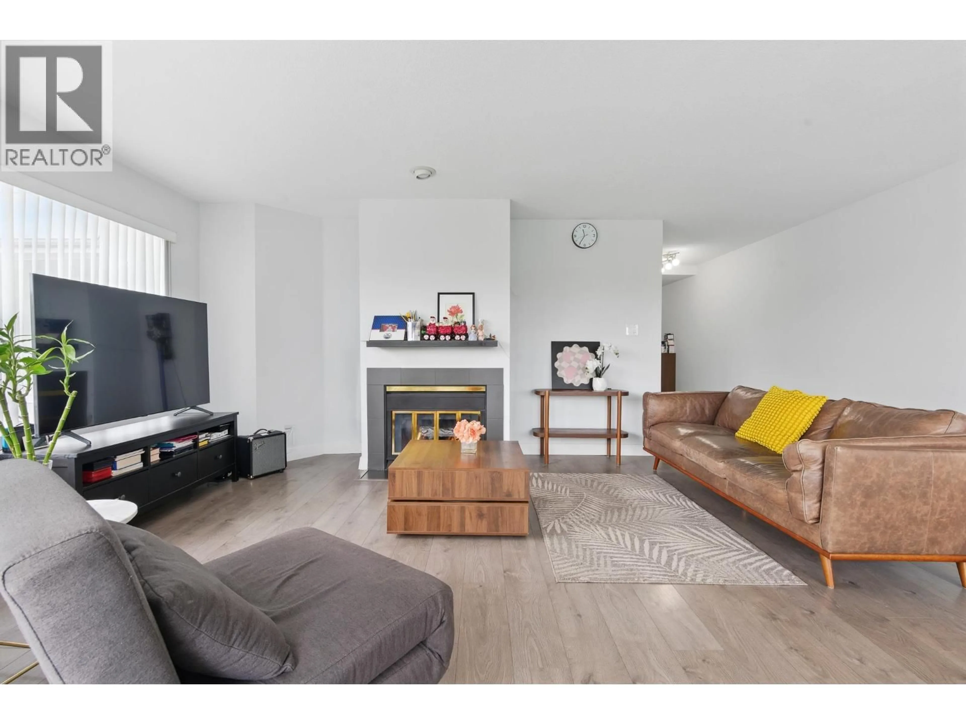 Living room with furniture, wood/laminate floor for 104 - 7480 GILBERT ROAD, Richmond British Columbia V7C3W2