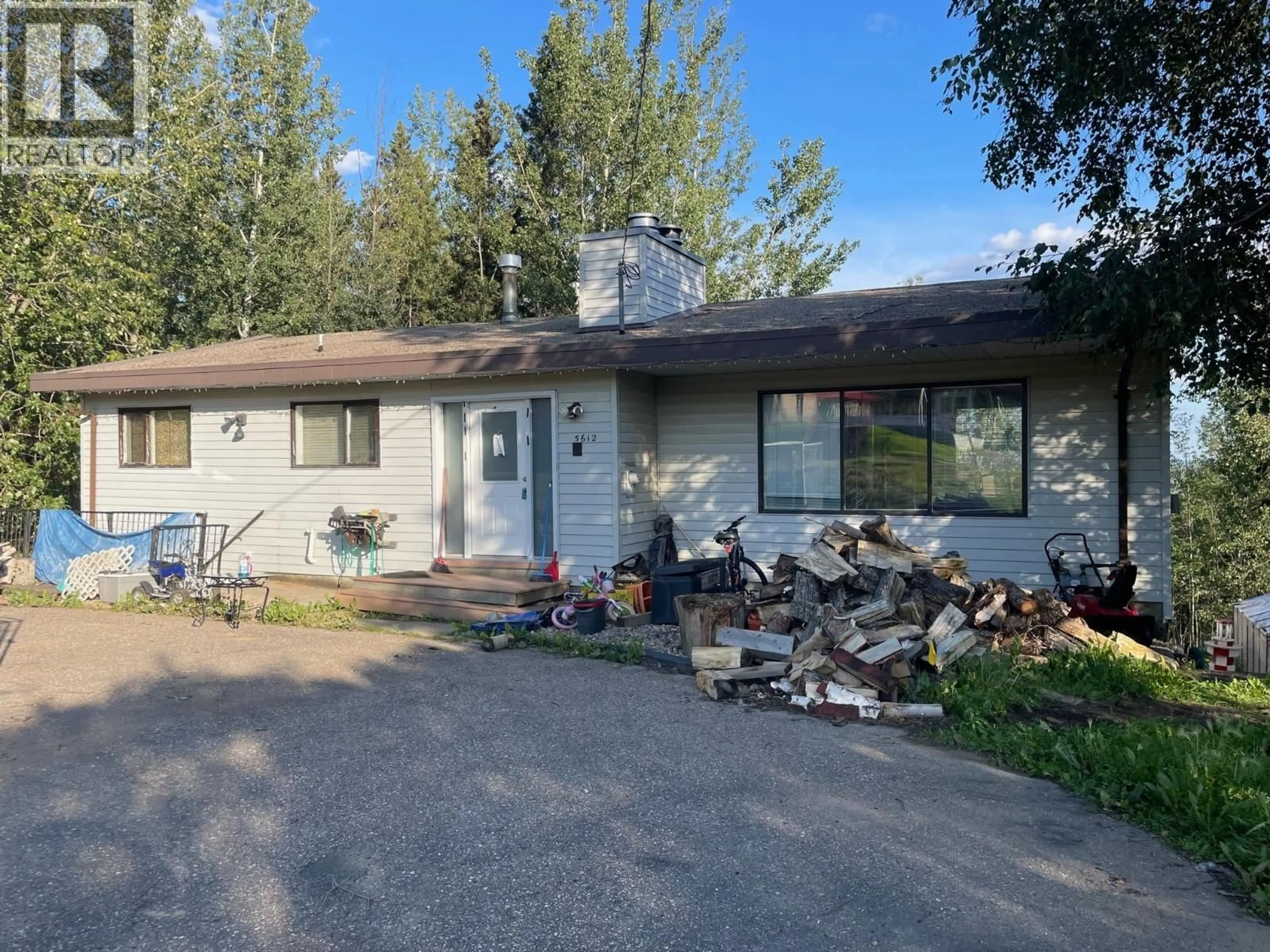 Home with vinyl exterior material, street for 5612 51 STREET, Fort Nelson British Columbia V0C1R0