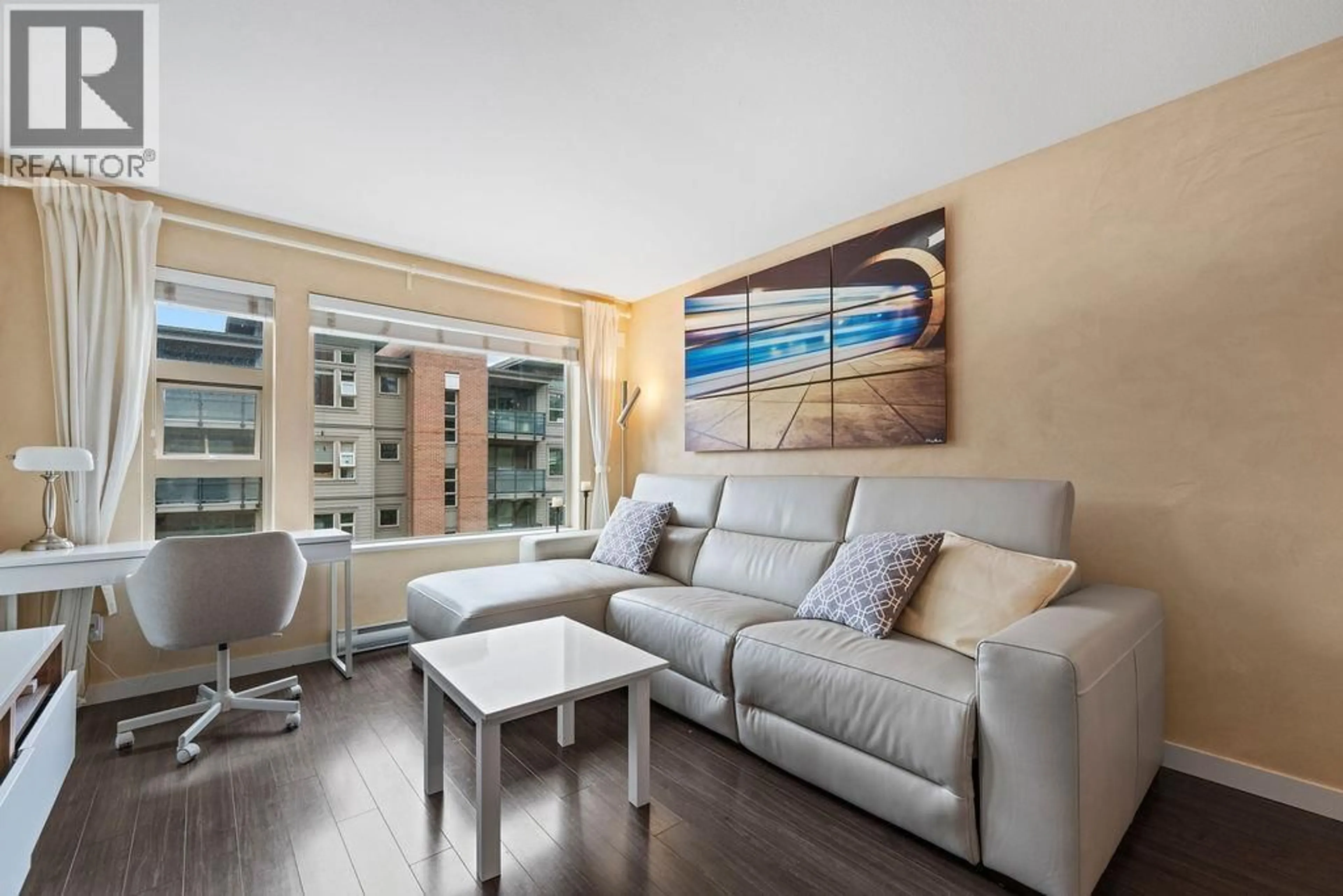 Living room with furniture, wood/laminate floor for 312 - 1679 LLOYD AVENUE, Vancouver British Columbia V7P0A9