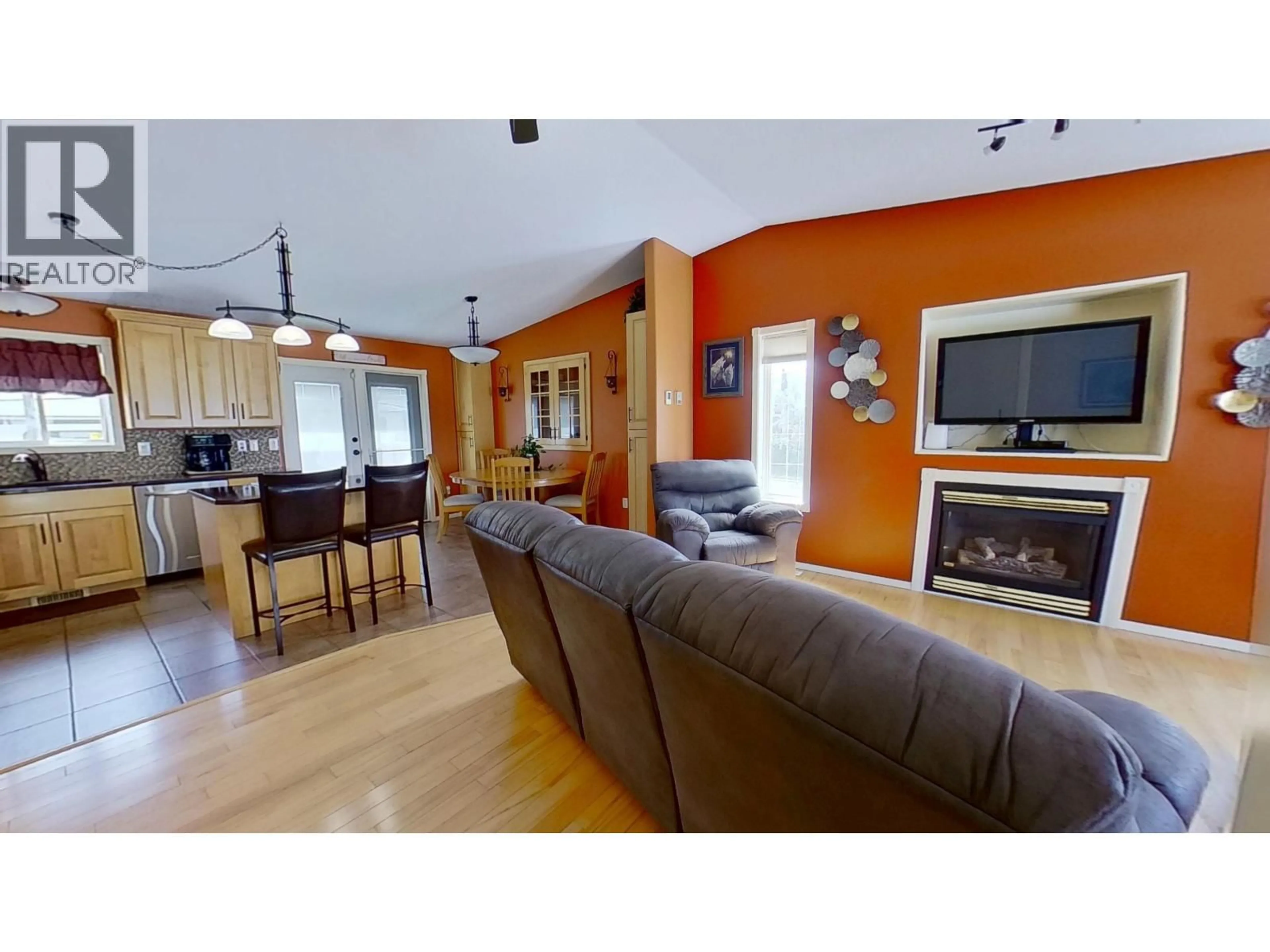 Living room with furniture, wood/laminate floor for 11323 90 STREET, Fort St. John British Columbia V1J6R2