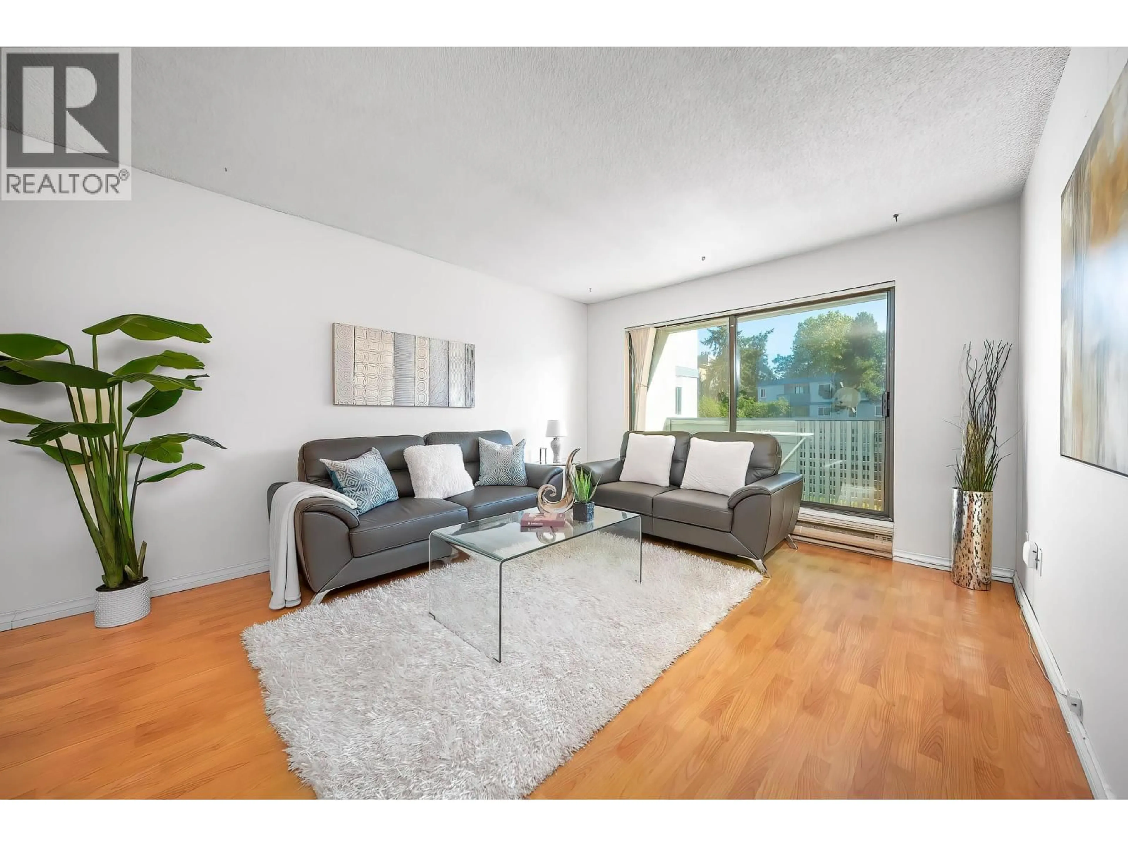 Living room with furniture, wood/laminate floor for 211 - 8700 ACKROYD ROAD, Richmond British Columbia V6X3G2